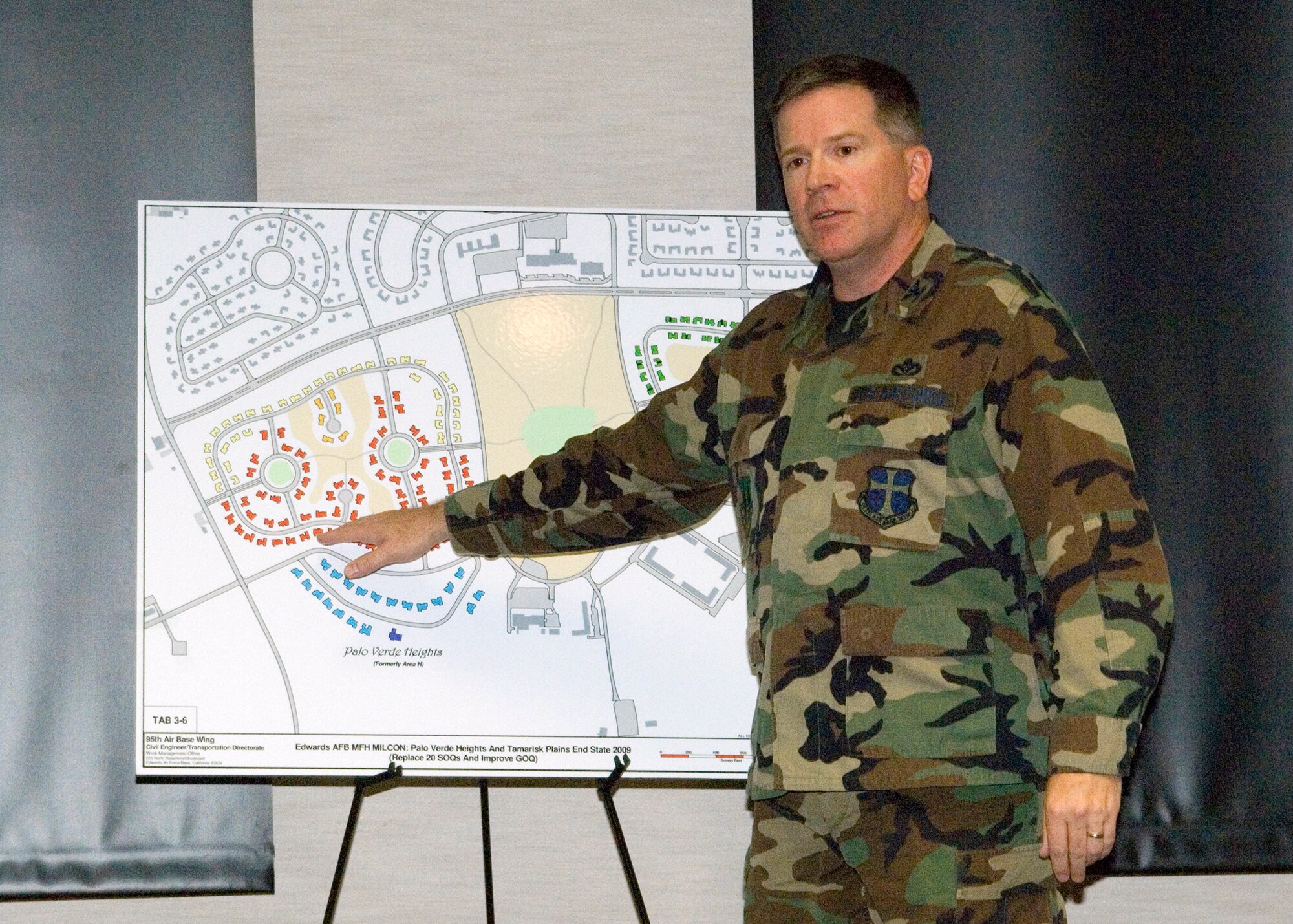 EDWARDS AIR FORCE BASE, Calif. -- Col. Bryan Gallagher, 95th Air Base Wing commander, explains the new housing move plan to Team Edwards at a town hall meeting in the Conference Center on June 15. The residential moves are part of the completion of the housing construction program. (Photo by Jim Shryne)