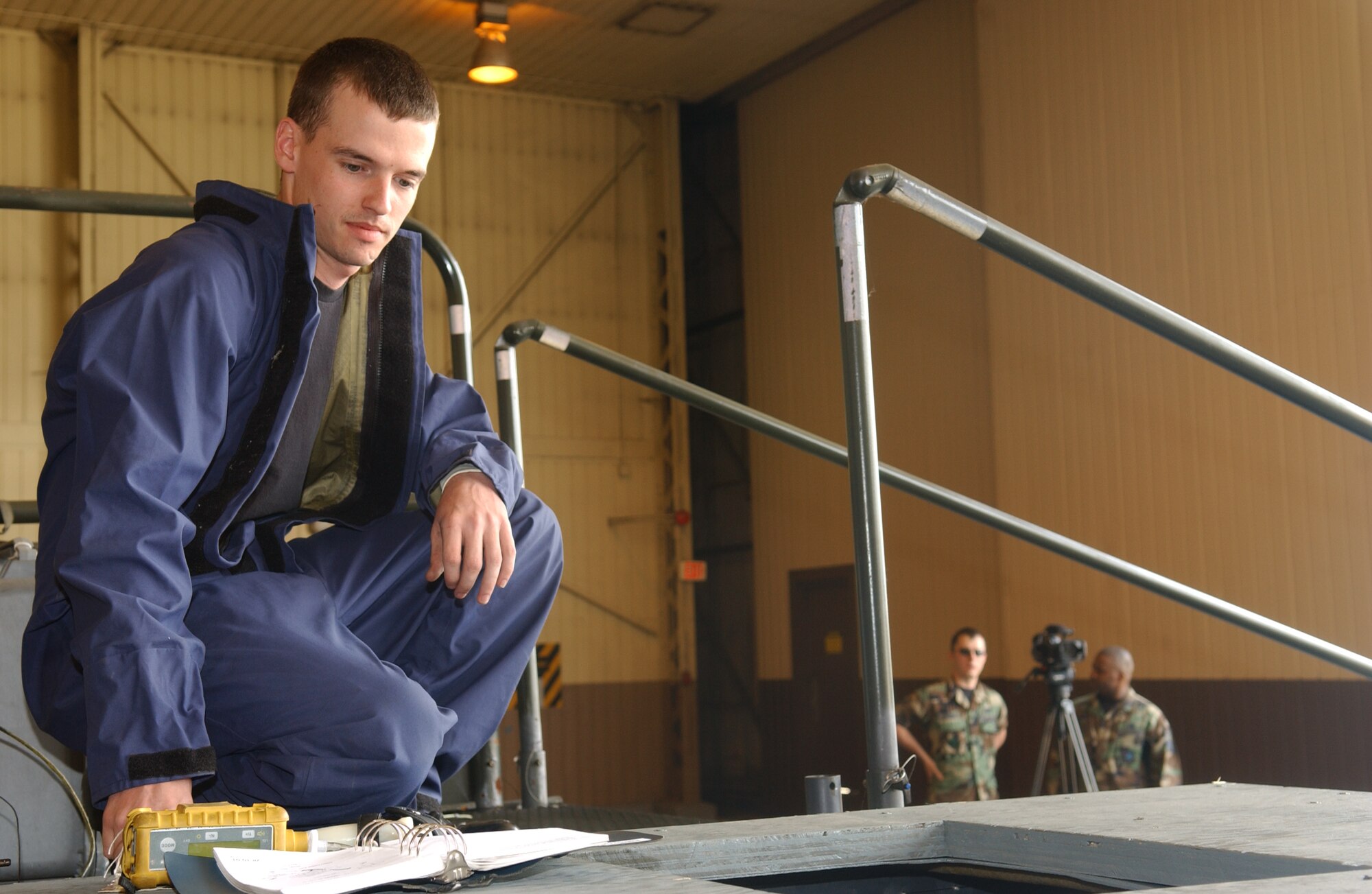 OSAN AIR BASE, Republic of Korea - Senior Airman Michael Teauge, 51st Maintenance Squadron fuel maintenance technician prepares a confined space trainer on June 15.  The trainer was used in an extraction exercise that tested the ability of the maintainers as well as 51st Civil Engineer fire department in the ability to remove individuals from confined spaces.  (U.S. Air Force photo by Staff Sgt. Christopher A. Marasky)