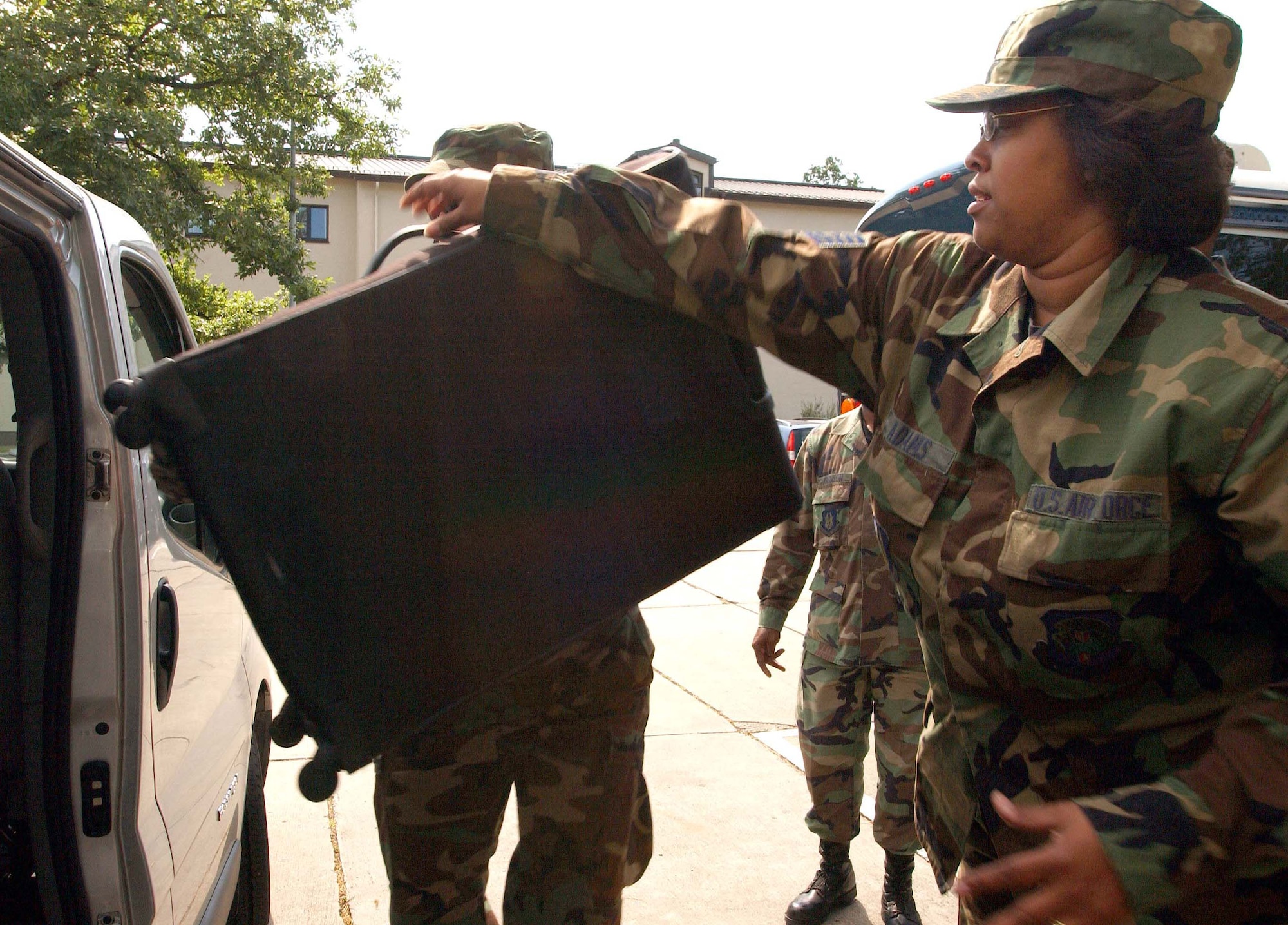 RAMSTEIN AIR BASE, Germany -- Tech. Sgt. Dionne Adams, 459th Mission Support Flight peronnelist, helps load her suitcase into a van at the end of a two-week annual tour at Spangdahlem Air Base, Germany June 17. Sergeant Adams supported the 52nd Operations Group at Spangdahlem AB. The 52nd OG is among the first consolidated commander's support staffs in U.S. Air Forces in Europe. (U.S. Air Force photo/Staff Sgt. Amaani Lyle)