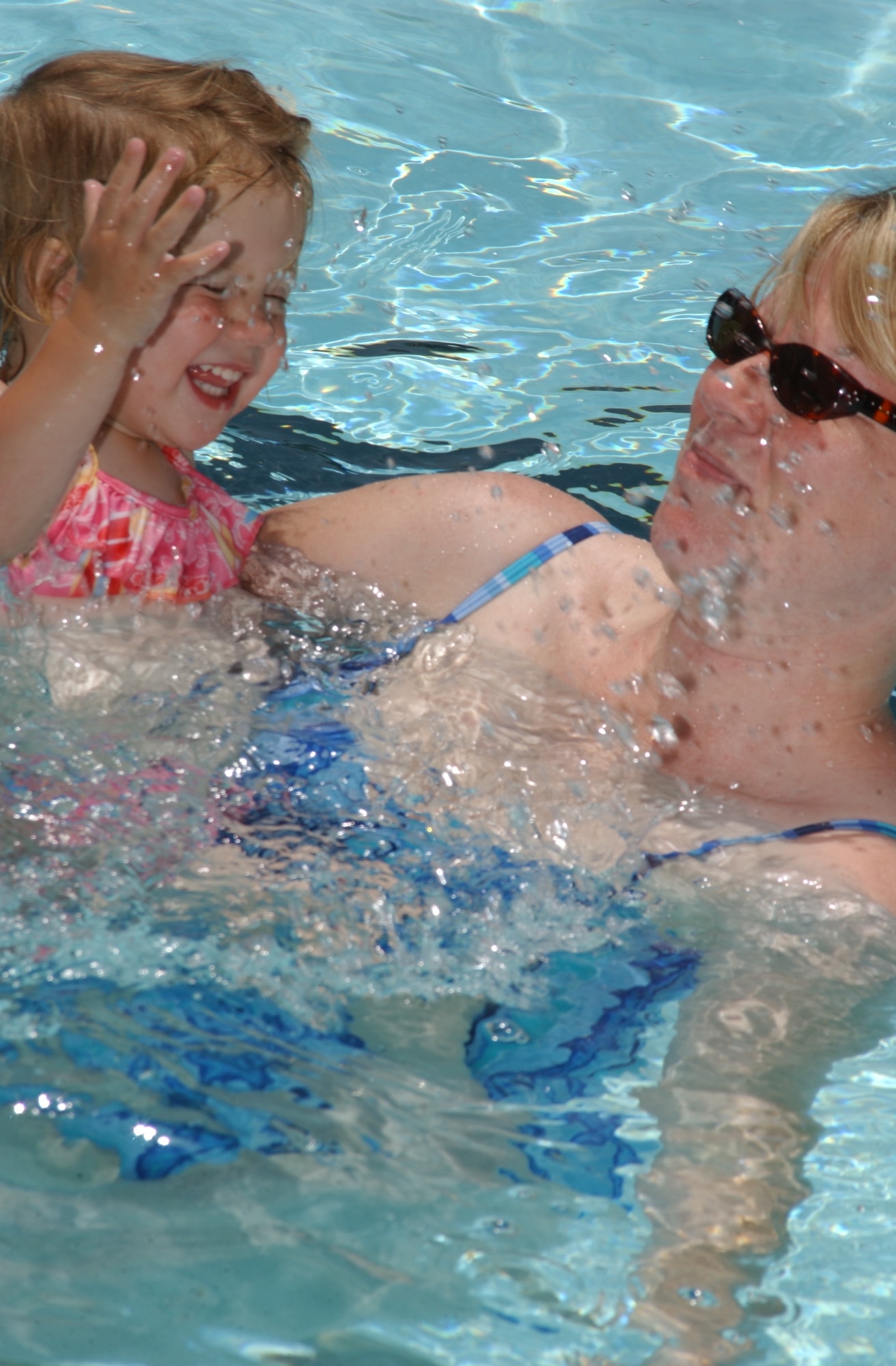 Two-year-old Kady Heverly, left, and her mother, Lisa Heverly, 81st Medical Operations Squadron, enjoy themselves at the main base pool June 8.  Keesler has two pools.  The main base pool is open noon to 5:30 p.m daily except Mondays.  The Triangle pool is open noon to 7 p.m. but is closed Wednesdays.  (U. S. Air Force photo by Kemberly Groue)