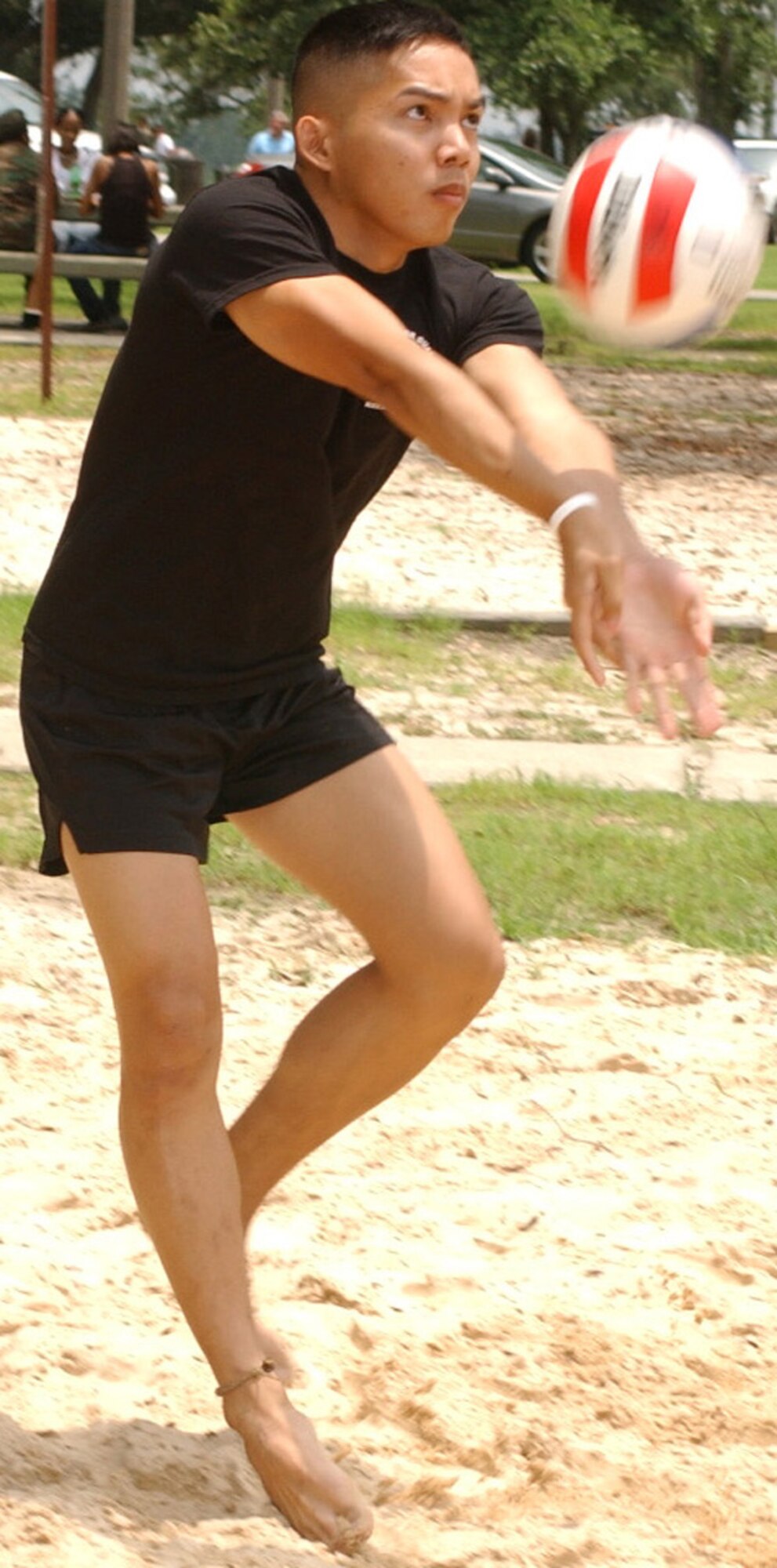 Staff Sgt. Michael DeGuzman, 81st Mission Support Group, gets a hit for the third-place honor guard team during the sand volleyball tournament.   The 81st Services Division won and the 81st Civil Engineer Squadron placed second.  (U. S. Air Force photo by Kemberly Groue)