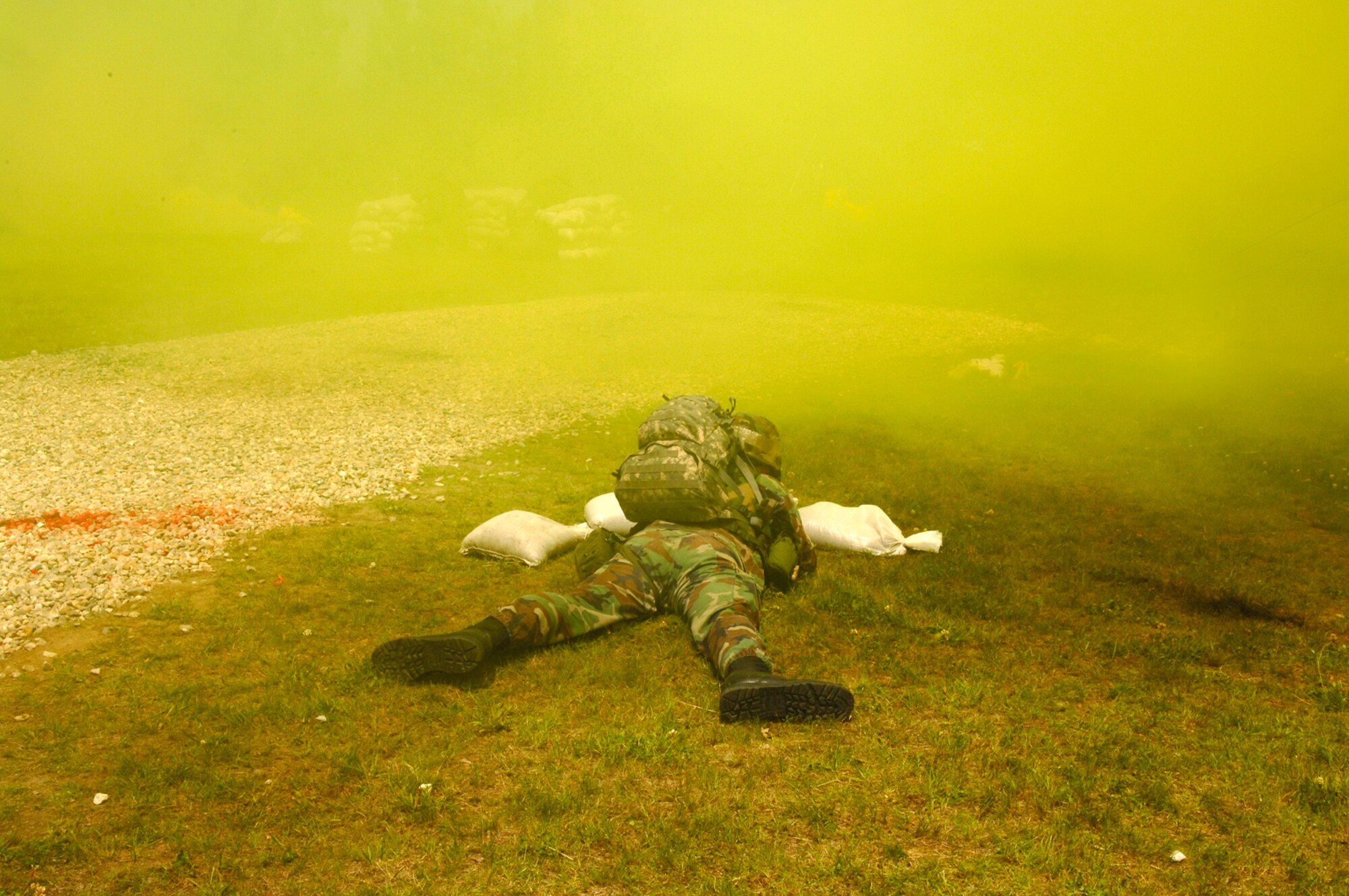 A servicemember takes protective actions during a simulated attacked at Camp Patriot during the base Operational Readiness Inspection. More than 70 inspectors visited Hanscom and put employees through their paces. (US Air Force photo by Jan Abate)