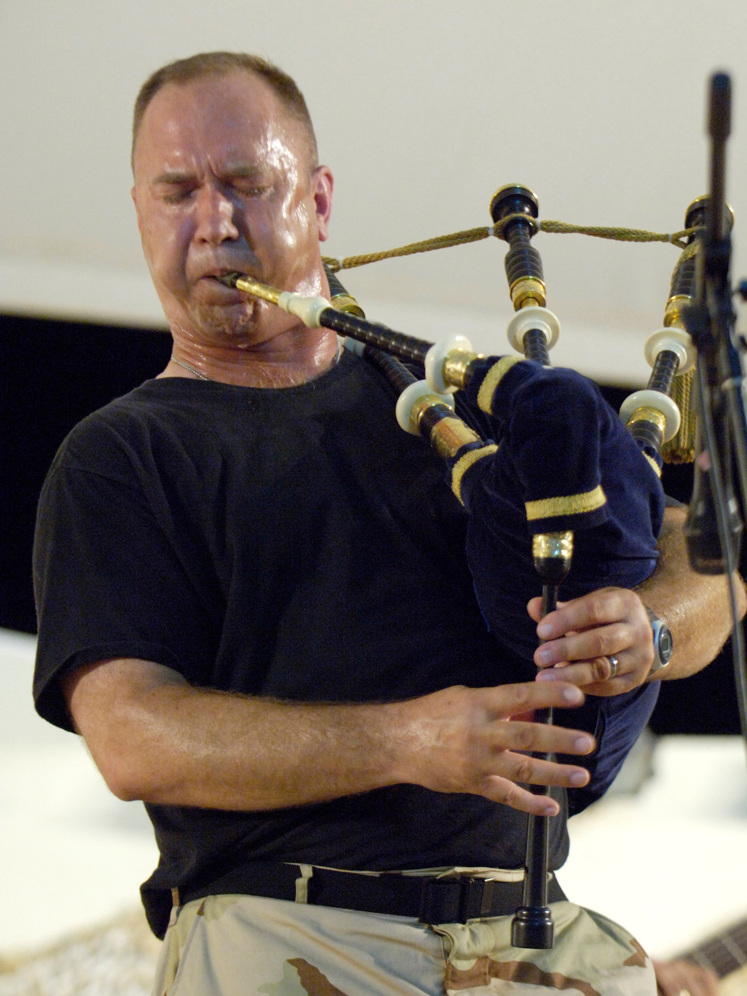 Master Sgt. Scott Gunn of the U.S. Central Air Forces Expeditionary Band "Live Round" performs at a concert in Southwest Asia June 16. "Live Round," along with "Thunder Roll," are bringing a touch of home to servicemembers fighting the war on terrorism. Sergeant Gunn is with the Air Force Reserve Command Band at Robins Air Force Base, Ga. (U.S. Air Force photo/Master Sgt. Jim Varhegyi) 