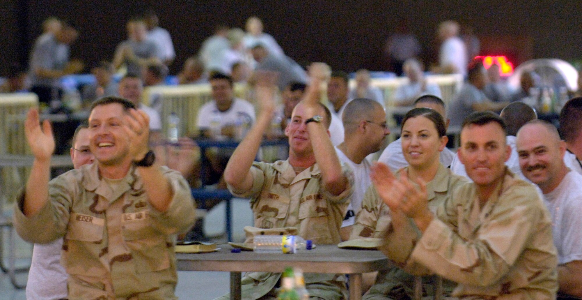 The crowd goes wild during the debut of the U.S. Central Air Forces Expeditionary Bands under their new names "Live Round" and "Thunder Roll." The bands played a combined kick-off concert for the deployed military members here June 16. "  (U.S. Air Force photo/Master Sgt. Jim Varhegyi) 