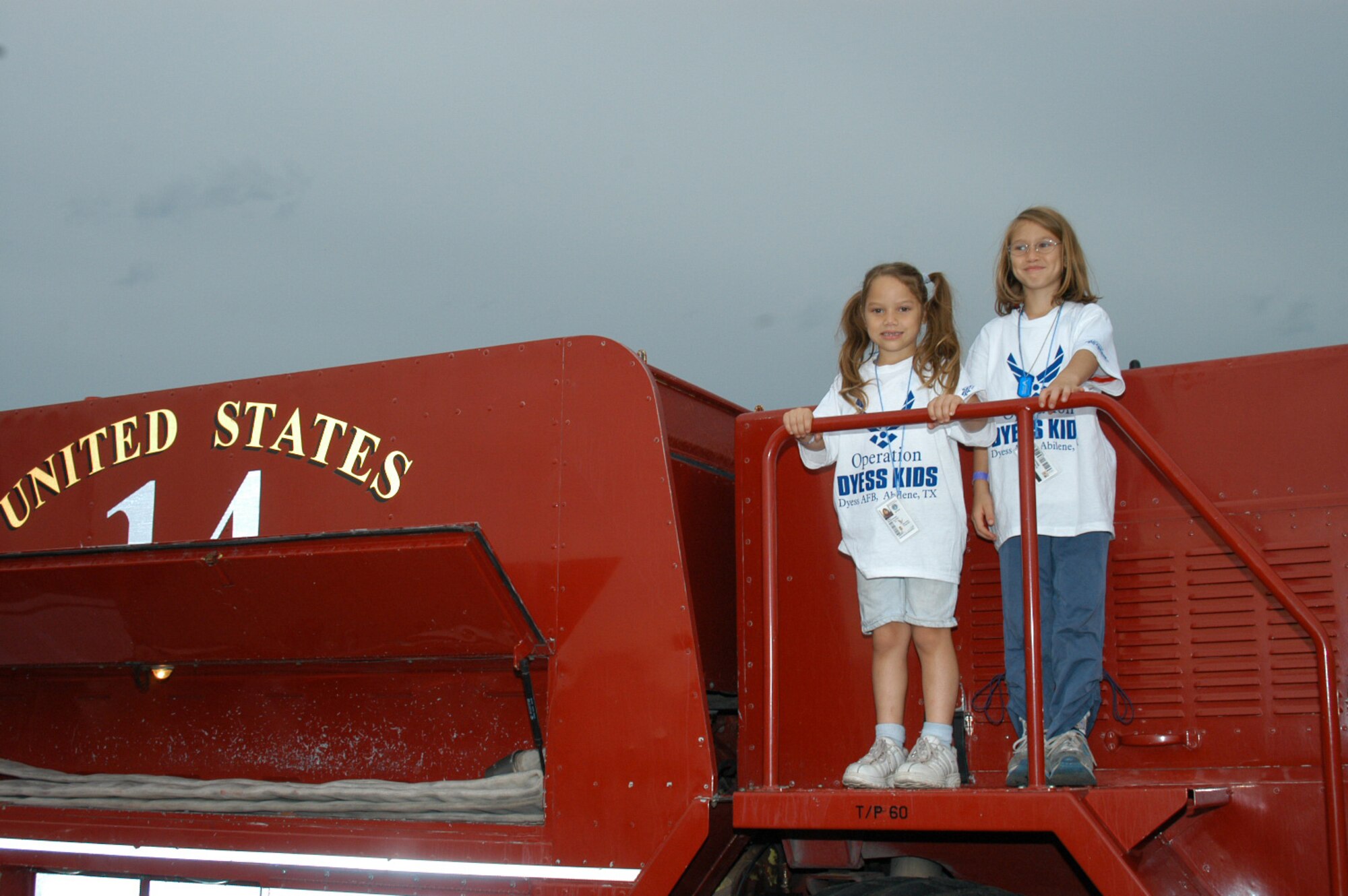 Laura and Sabrina Santos, ages 8 and 5, daughters of Tech. Sgt. Christopher Santos, 317th Maintenance Operations Squadron, climb a fire truck during Operation Dyess Kids June 15. (U.S. Air Force photo/Airman 1st Class Carolyn Viss)                                
