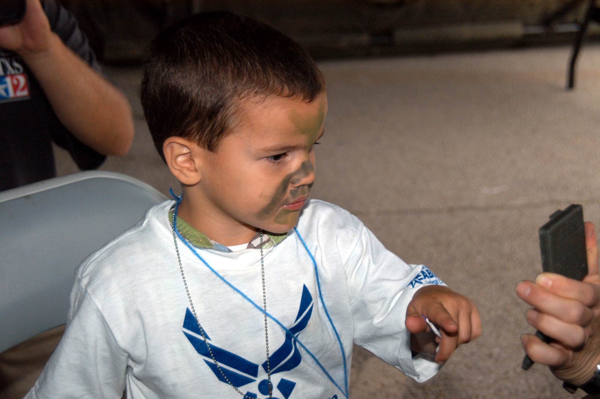 Kyle Philipp, 3, checks out his newly-painted face at Operation Dyess Kids June 15. The event brought children of military families through a pseudo-deployment process to show them -- in a fun way -- what their parents go through (U.S. Air Force photo/Airman 1st Class Carolyn Viss)