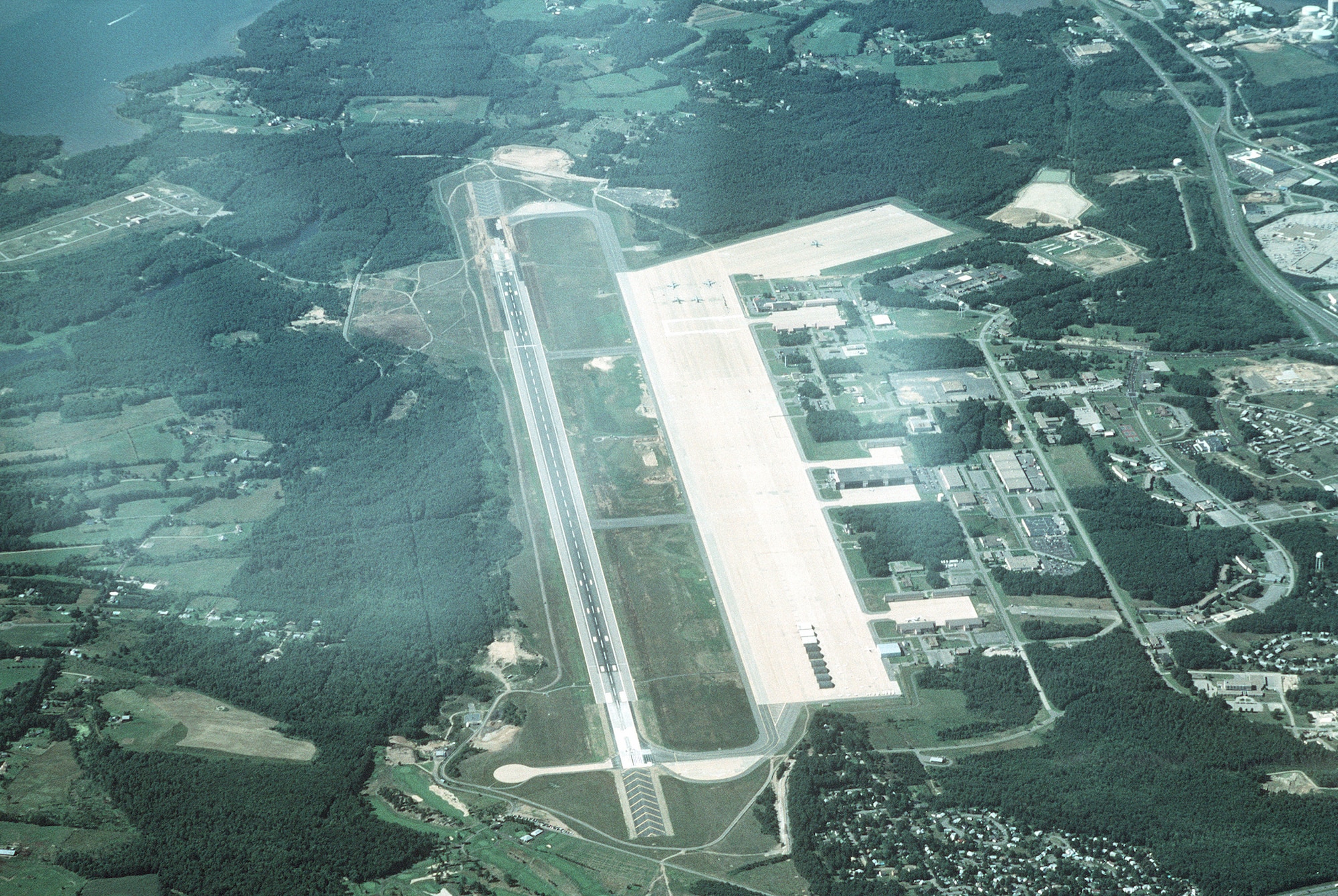 High oblique aerial view, looking north of Pease Air National Guard Base, formerly Pease Air Force Base, N.H. This joint use civil and military airfield is home to the 157th Air Refueling Group flying KC-135R Stratotankers for the New Hampshire Air National Guard.