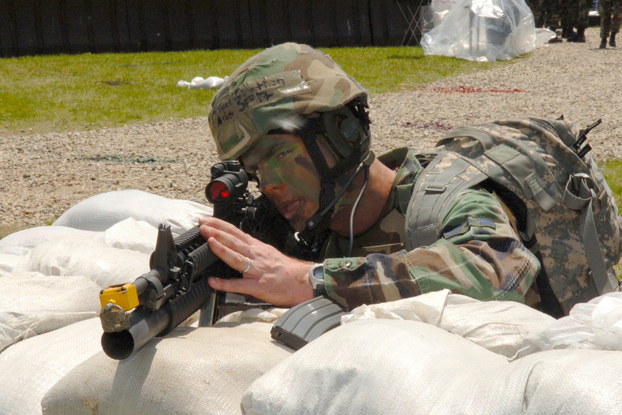 Airman 1st Class Johnathan McKean, 66th Security Forces Squadron, takes aim during deployed operations at Camp Patriot on June 15. Airman McKean along with other Hanscom servicemembers, practiced various deployment skill during the Hanscom Operational Readiness Inspection. The base was tested on its ability to handle numerous scenarios including initial response, emergency management, and deployed operations. (US Air Force photo by Jan Abate)