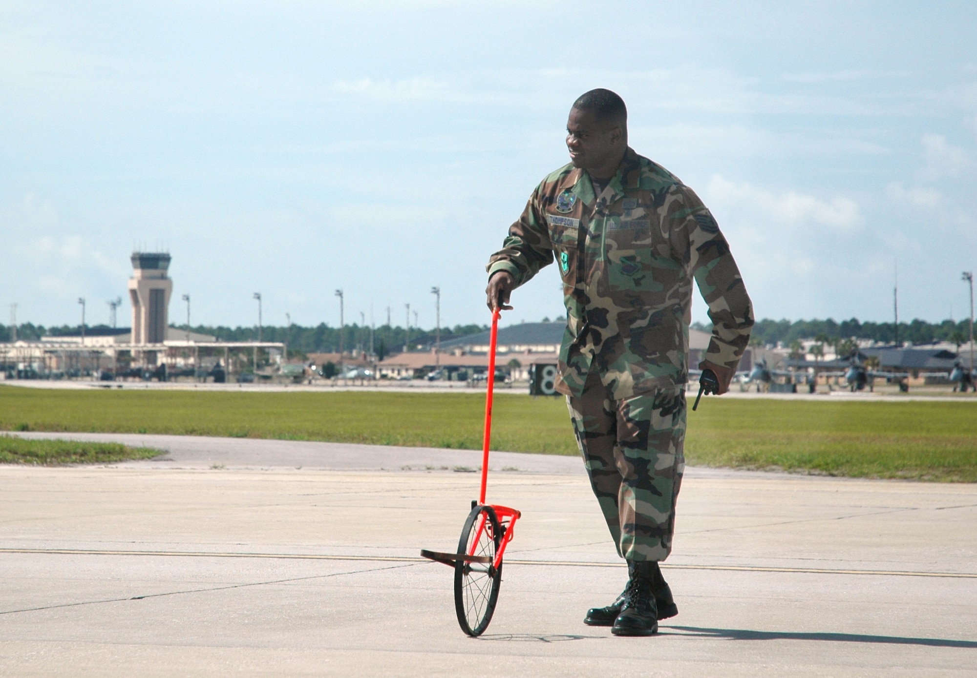 Tech. Sgt. Nick Thompson, 325th Operations Support Squadron deputy airfield manager, uses a measuring wheel to determine if there is enough aircraft clearance on a taxiway under construction at Tyndall. His team was awarded “Airfield Management Facility of the Year” by Air Force officials who announced the winners June 13.