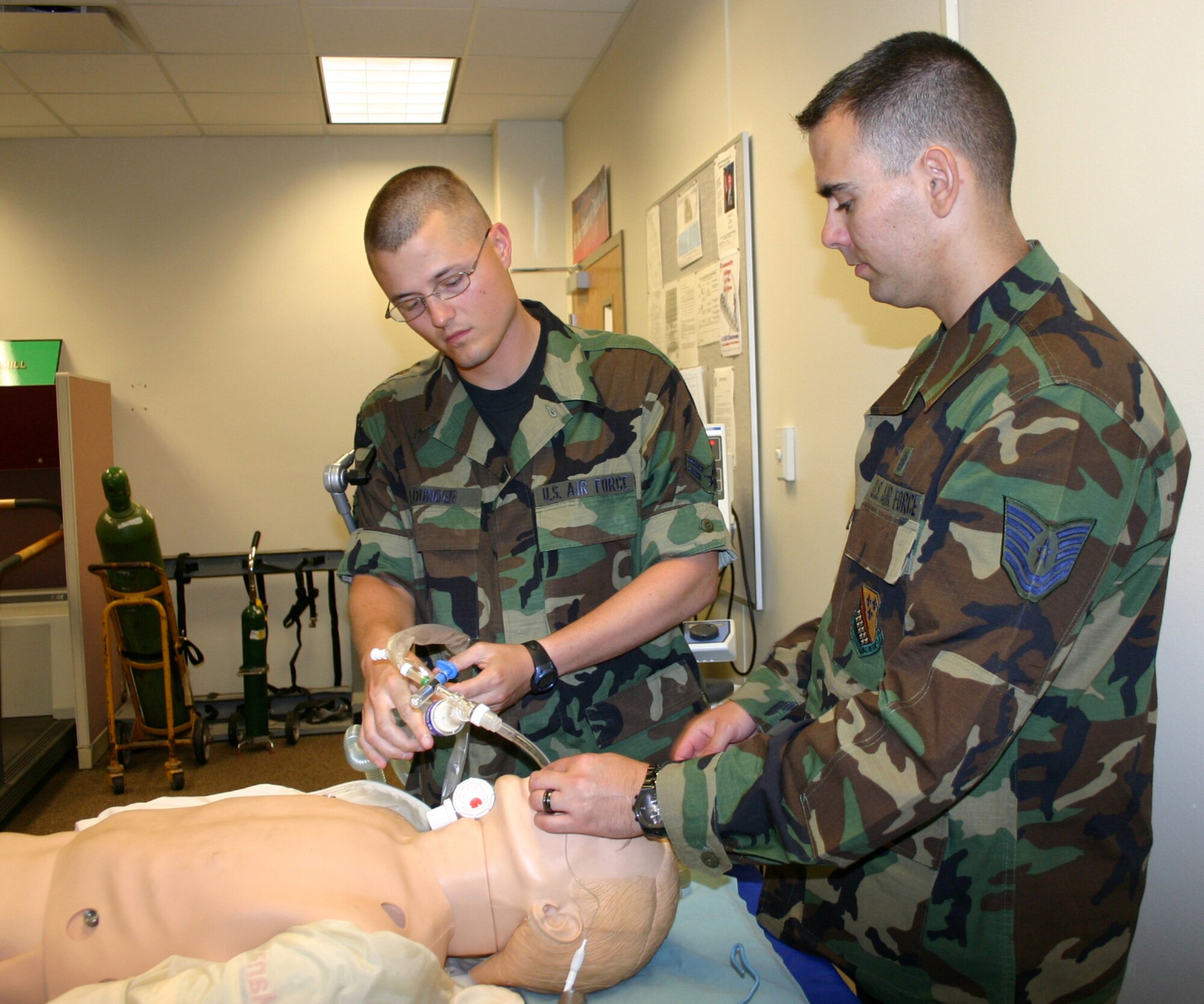Airman 1st Class Justin Lounder, 882nd Training Squadron, hooks his "patient" up to a ventilator as Tech. Sgt. James Woods, 383rd Training Squadron, supervises during the cardiopulmonary course.  The course, sponsored by the 882nd Training Group, has recently been upgraded from an entry-level course to an advanced-level course. (U.S. Air Force photo/Staff Sgt. Tonnette Thompson)