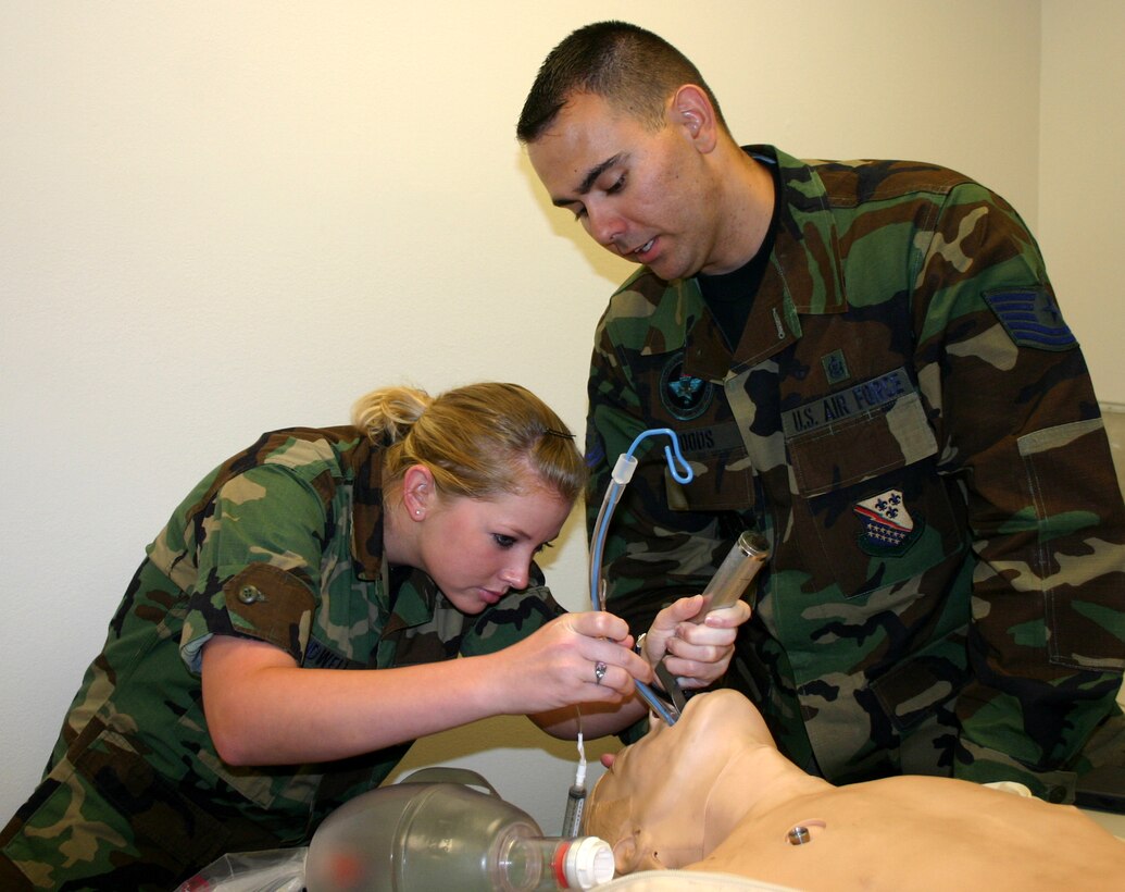Tech. Sgt. James Woods, 383rd Training Squadron, instructs 882 Training Squadron Airman Maegan Kidwell as she practices intubating a patient during the cardiopulmonary course.  The course, sponsored by the 882nd Training Group, has recently been upgraded from an entry-level course to an advanced-level course. (U.S. Air Force photo/Staff Sgt. Tonnette Thompson)