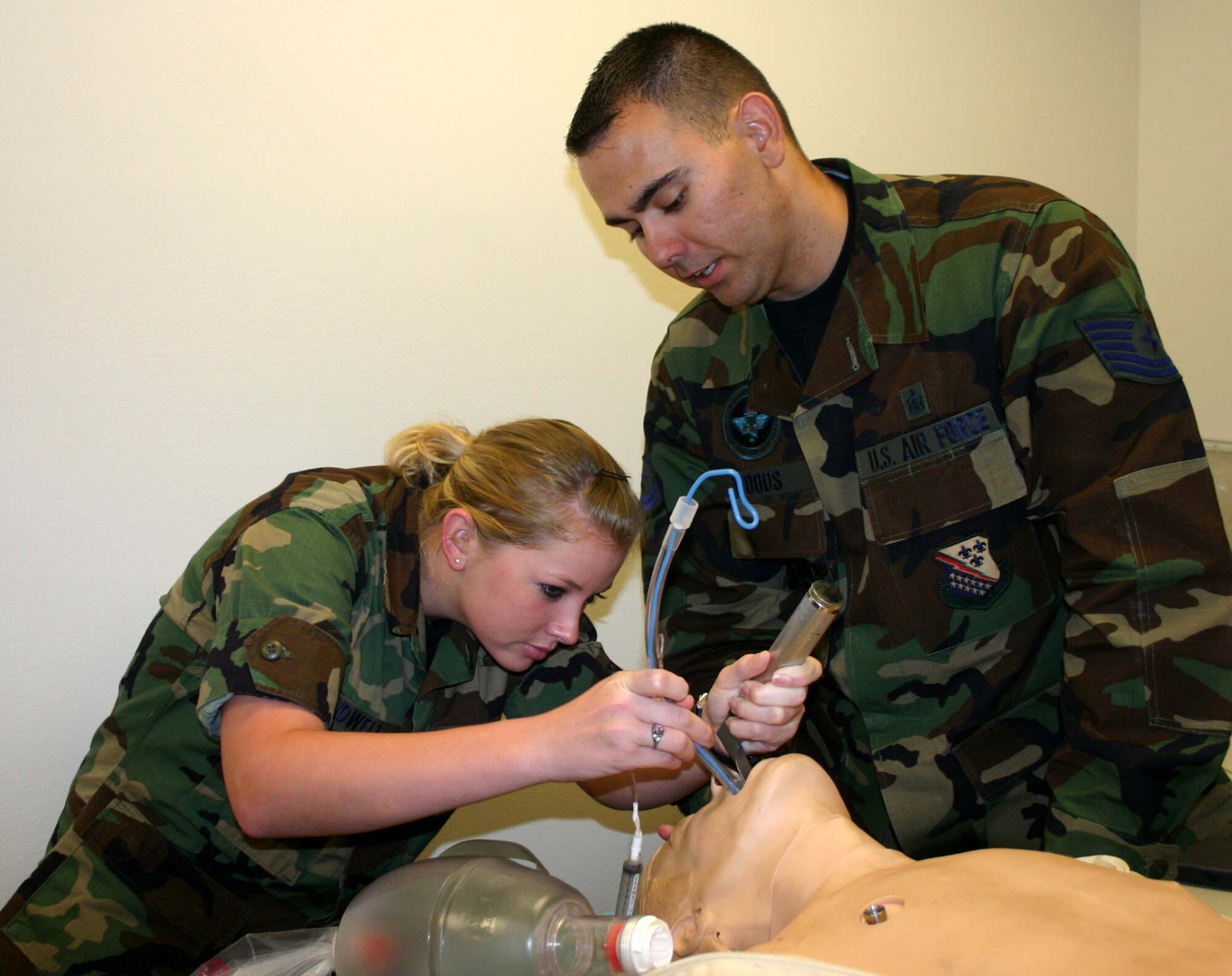 Tech. Sgt. James Woods, 383rd Training Squadron, instructs 882 Training Squadron Airman Maegan Kidwell as she practices intubating a patient during the cardiopulmonary course.  The course, sponsored by the 882nd Training Group, has recently been upgraded from an entry-level course to an advanced-level course. (U.S. Air Force photo/Staff Sgt. Tonnette Thompson)