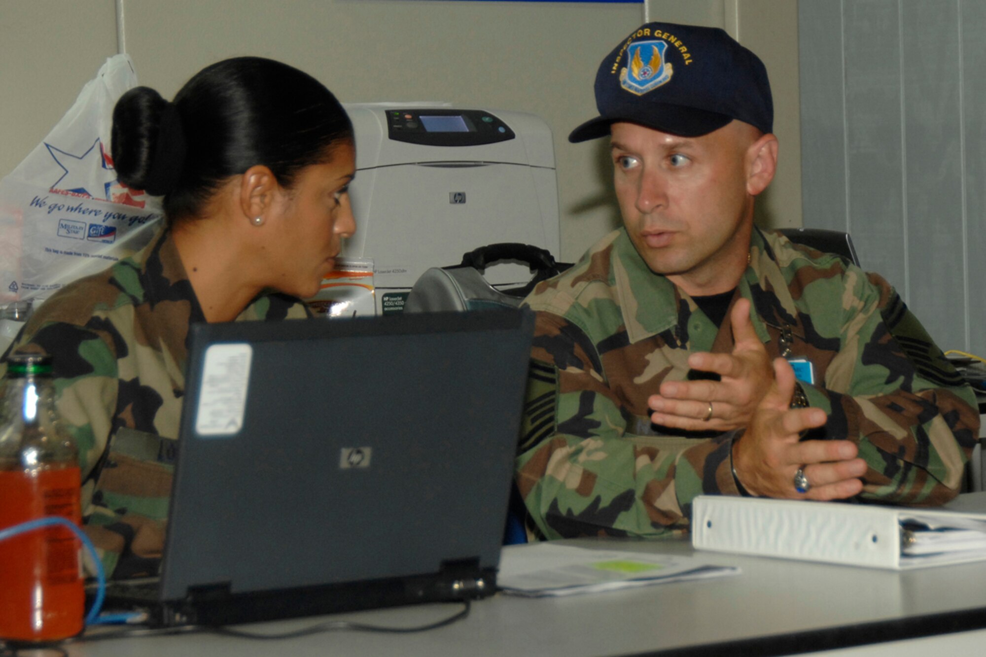 From left, Tech. Sgt. Shannon Lopez, 66th Medical Operations Squadron, speaks with a member of the Air Force Materiel Command Operational Readiness Inspection team June 11 while processing “deployers” through a mock deployment line.The ORI began on June 7 and ran until June 18. (US Air Force photo by Linda LaBonte Britt)