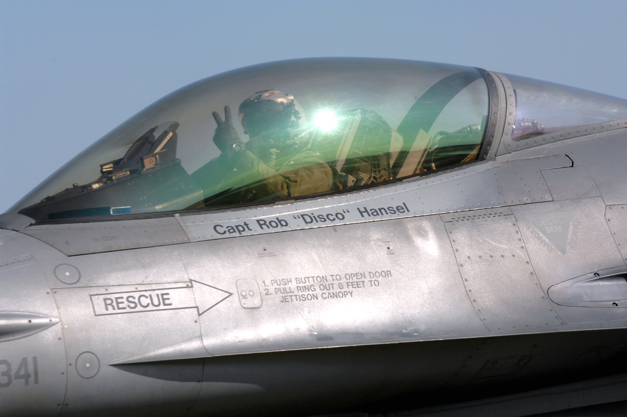 Capt. Robert Hansel shows his pride as he taxis his F-16 Fighting Falcon to the runway June 11 on Spangdahlem Air Base, Germany, to fly en route to Nellis Air Force Base, Nev. Captain Hansel is one of many pilots and crews from the 22nd, 23rd and 81st Fighter Squadrons leaving the base to continue flying missions and training in other locations while the runway gets repaired. Captain Hansel is assigned to the 22nd FS. (U.S. Air Force photo/Senior Airman Josie Kemp)