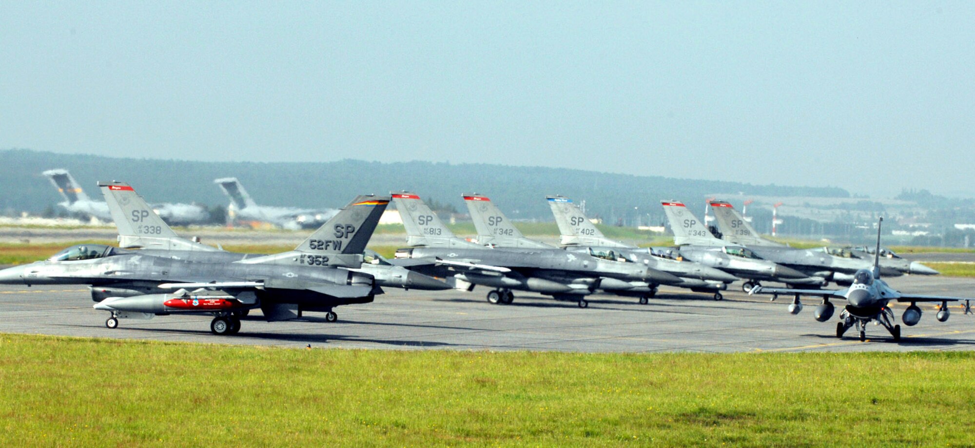 Pilots from the 22nd Fighter Squadron taxi F-16 Fighting Falcons out to the runway June 11 in preparation for their flight to Nellis Air Force Base, Nev. Pilots and crew members from the 22nd FS 23rd and 81st Fighter Squadrons leaving the base to continue flying missions and training in other locations while the runway gets repaired. (U.S. Air Force photo/Senior Airman Josie Kemp)