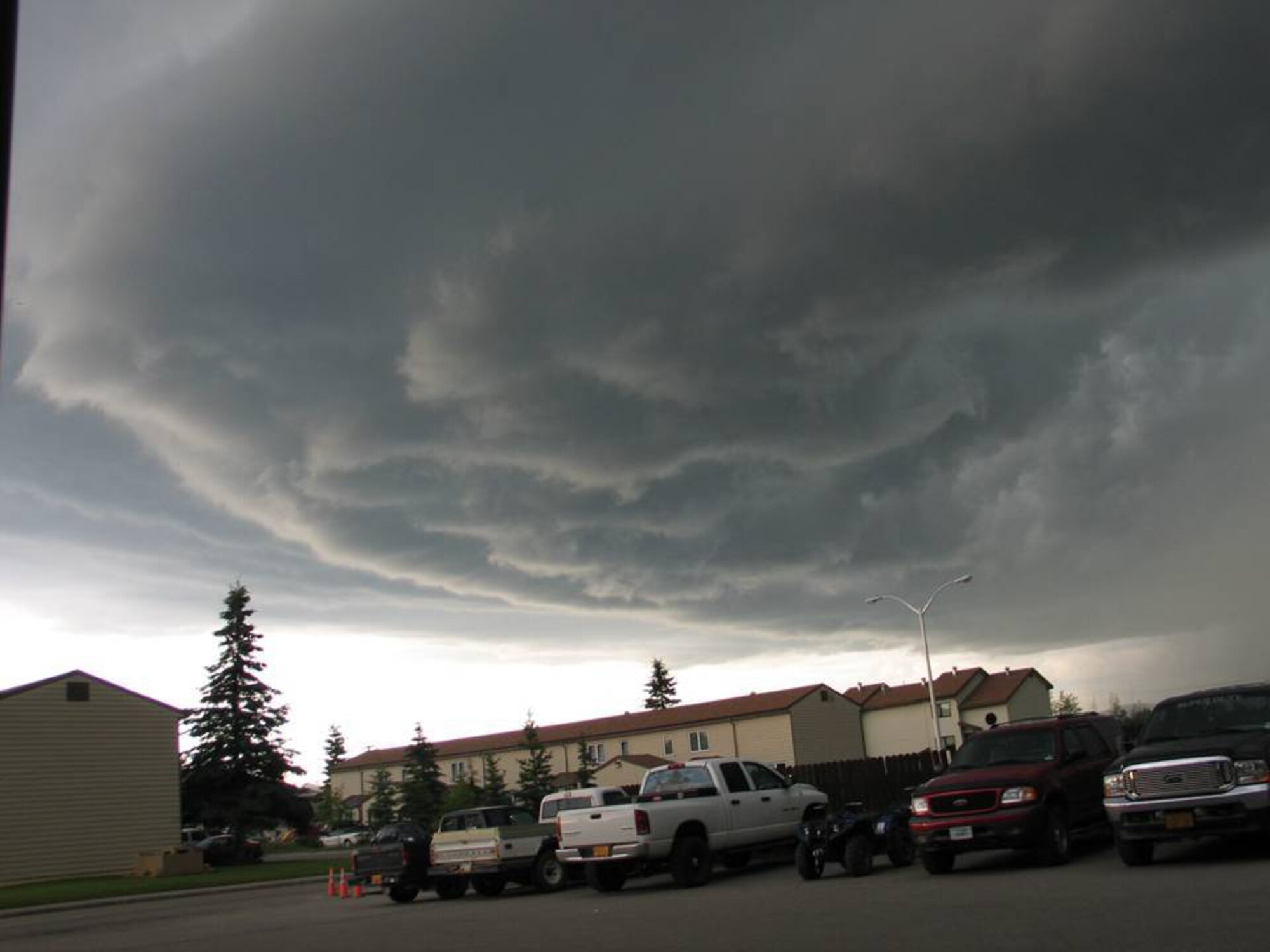 EIELSON AIR FORCE BASE, Alaska--Storm clouds roll over base housing during a thunderstorm the evening of June 17 on base. Lightening storms are somewhat rare to base residents, however it is not uncommon for thunderstorms to occur in Alaska. In an average Alaska summertime, Alaska can see just as much, if not more lightening than Florida. Most thunderstorms that happen in the interior Alaska are unseen due to seclusion on a range; the ones that are seen are extremely visible as the atmosphere gets thinner closer to the North Pole (and South Pole) and storms generally sit closer to ground because of that. (U.S. Air Force photo by Staff Sgt. Kevin Carter)