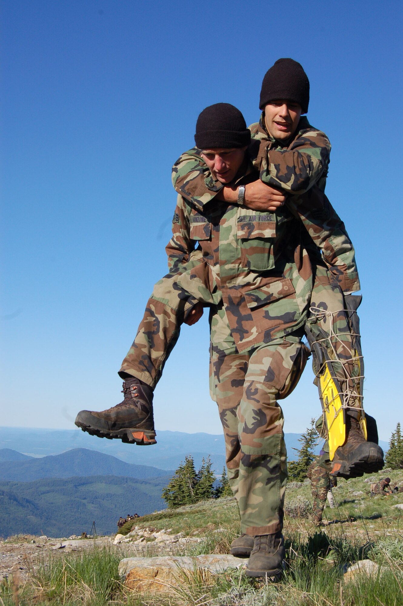 Senior Airman Gailin Manzonie carries his teammate, Senior Airman Cody Speckman, up to the top of Calispell Peak during a medical evacuation exercise as part of the 2007 SERE Challenge at the Colville National Forest north of Fairchild Air Force Base, Wash.  (U.S. Air Force photo by Staff Sgt. Matthew Rosine)