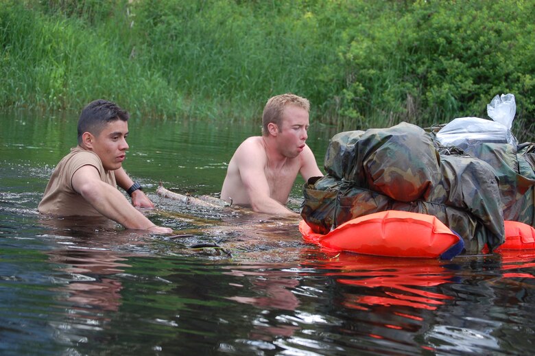 Competitors in the 2007 SERE Challenge feel the pain as they push a raft into the 45 degree waters of Sportsman's Pond during the competition June 12.  (U.S. Air Force photo by Staff Sgt. Matthew Rosine)