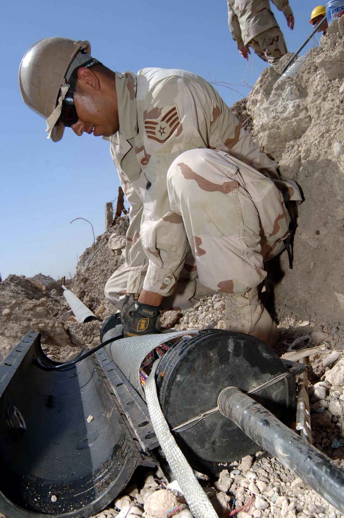 Staff Sgt. Erik Castilleja packs up 400 phone wires in a splice box to be buried at Sather Air Base, Iraq. Sergeant Castilleja is a cable and antenna technician assigned to the 447th Expeditionary Communication Squadron. (U.S. Air Force photo/Tech. Sgt. Russell Wicke) 