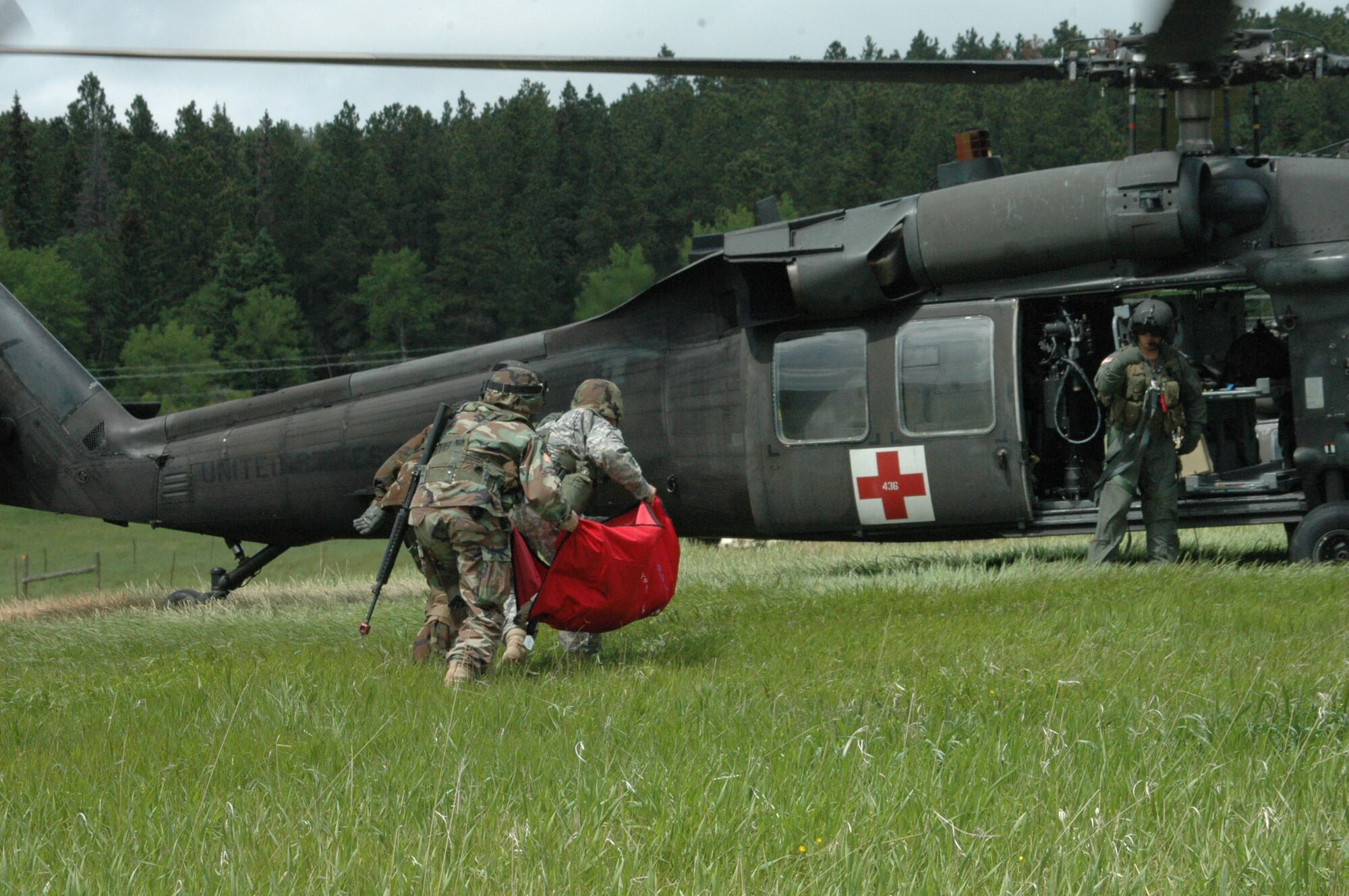 Service members carry a simulated injured K9 to seek medical attention during the exercise Join Thunder. 
Airmen participate in Joint Thunder 2007 for the first time in the exercise's existence. Joint Thunder is a realistic field training exercise which includes Army, Navy and Air Force units from 34 states, Canada, Singapore and Germany. Joint Thunder exercises provide better trained medics who are fully prepared to support the Global War on Terror, also it builds a better joint medical team. Medics gain knowledge on convoy operations, receive training in land navigation and participate in the Leadership Reaction Course. 
(U.S Air Force photo/Airman 1st Class Kimberly Moore Limrick)