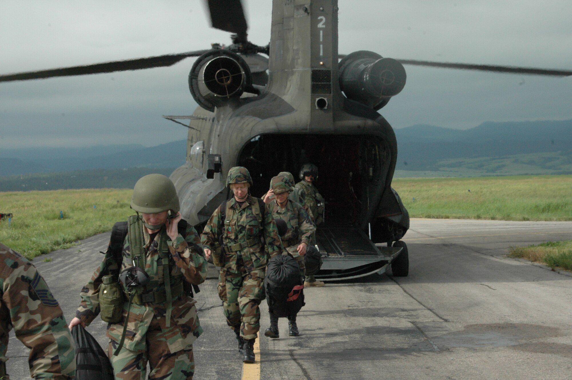 Col. Naomi Boss, 28th Medical Group commander and members of the 28th MDG executive staff disembark from an Army Chinook helicopter at Sturgis field during exercise Joint Thunder June 16. Colonel Boss and her staff spent the night at Sturgis but had to evacuate due to severe weather conditions. (U.S. Air Force photo/Tech. Sgt. Todd Wivell)
