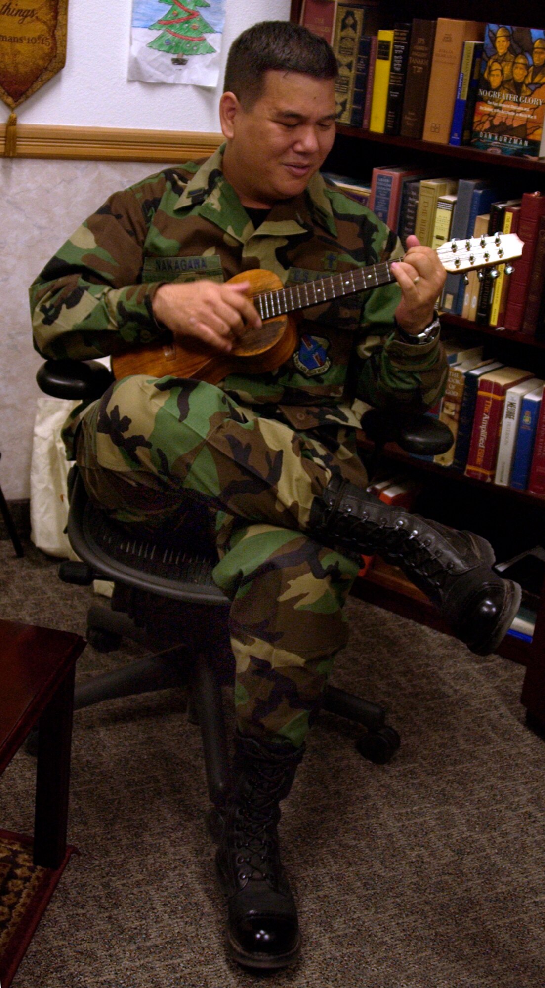 1st Lt. Craig Nakagawa, native of Pukalani, Maui, and a chaplain here, is engaging in one of his favorite forms of ministry - singing a peaceful Hawaiian song.