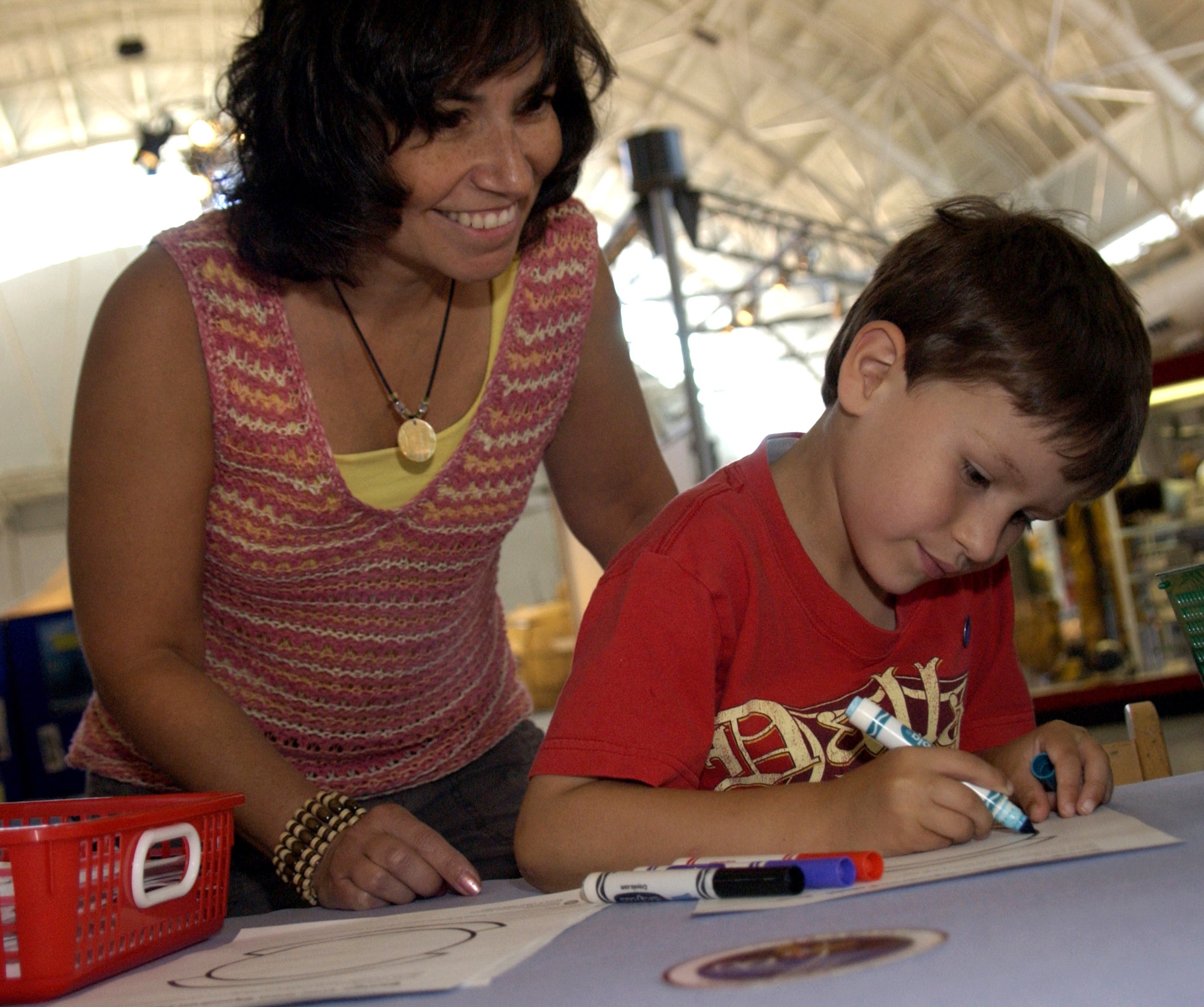 Nicholas Willey, age 5, and his mom, Anne Ellis, design their own Air Force patch June 16 during the "Reach for the Sky" family day at the National Air and Space Museum's Udvar-Hazy Center in Chantilly, Va. The airshow featured several static civilian and military aircraft in addition to the museum's vast array of air and space displays. More than 17,000 people attended the event, which also honored the Air Force's 60th Anniversary as a separate service. (U.S. Air Force photo/Staff Sgt. J.G. Buzanowski) 