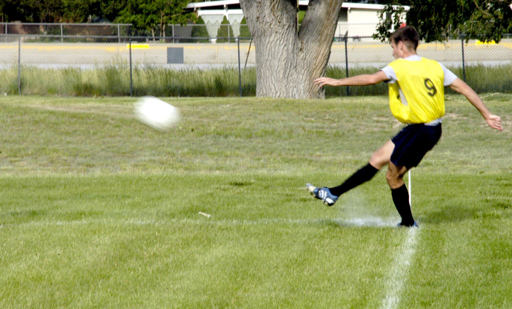 First Lt. Cody Fournier, 320th Missile Squadron, puts the ball in play for the 90th Operations Group team by performing a corner kick at the base soccer field Monday.  The 90th OG team beat the 153rd Air Wing team with a score of 2-1 (Photo by Airman 1st Class Daryl Knee).