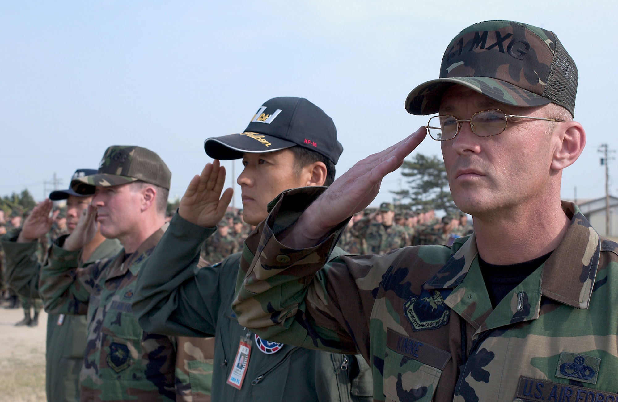 KUNSAN AIR BASE, Republic of Korea -- Airmen from the 51st Maintenance Group at Osan Air Base, South Korea, and members of the Republic of Korea Air Force stand in formation during the 8th Fighter Wing's commemoration event June 19.  The memorial service honored the memory of "Wolf 1", Brig Gen. Robin Olds, who recently passed away.  (U.S. Air Force Photo/Senior Airman Barry Loo)                 