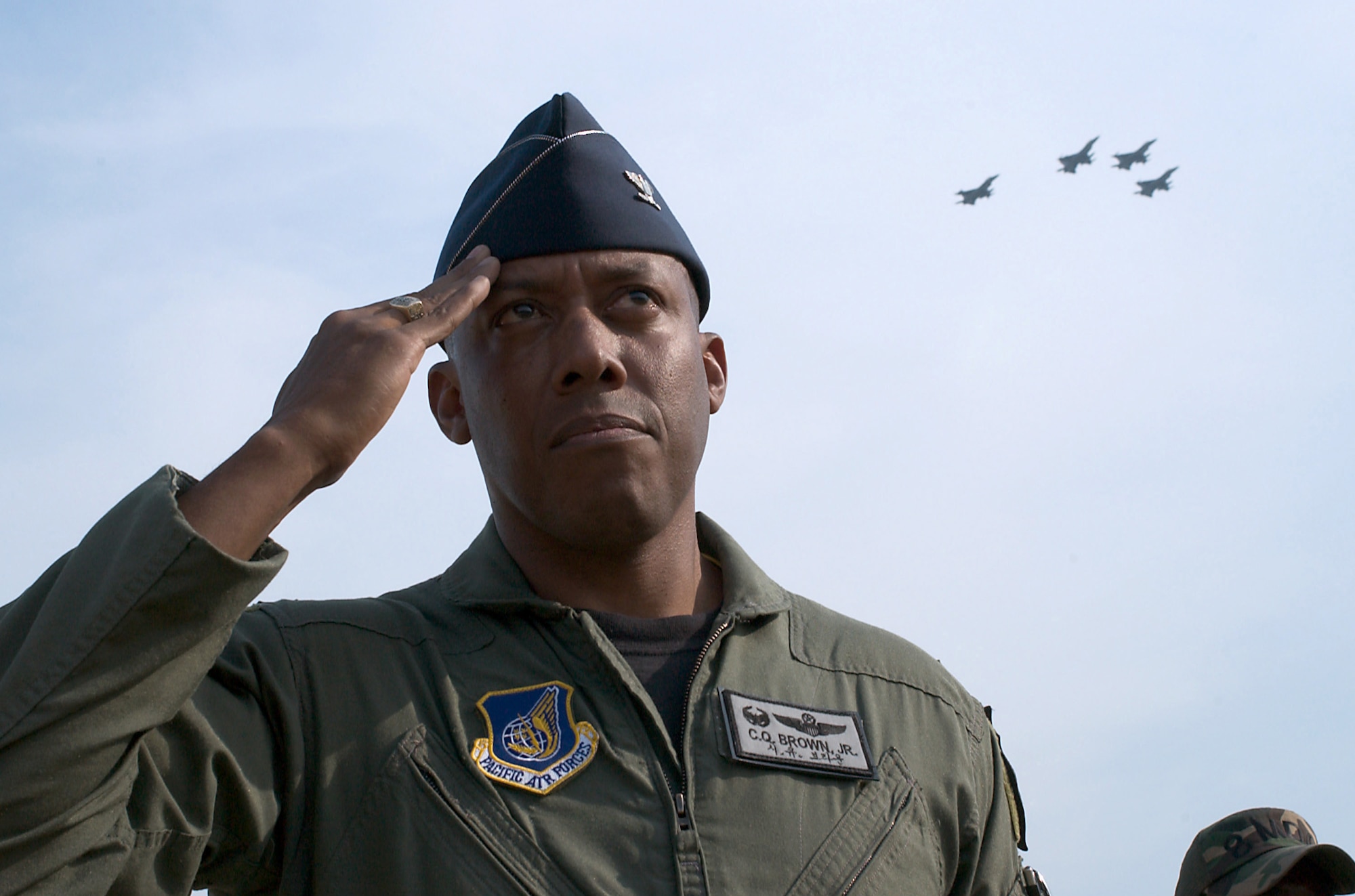 KUNSAN AIR BASE, Republic of Korea -- Col. CQ "Wolf" Brown, 8th Fighter Wing commander, salutes the flag during a the wing's commemoration event June 19.  The memorial service honored the memory of "Wolf 1", Brig. Gen. Robin Olds, who recently passed away.  (U.S. Air Force Photo/Senior Airman Barry Loo)                     