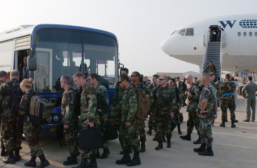 KUNSAN AIR BASE, Republic of Korea -- Airmen from the 555th Fighter Squadron, Aviano Air Base, Italy, load onto a bus here at Kunsan Air Base, Republic of Korea for their 120 day deployment.  This is the first time that a United States Air Forces in Europe base has deployed to a Pacific Air Force base.  (US Air Force photo/ Senior Airman Steven R. Doty)                               