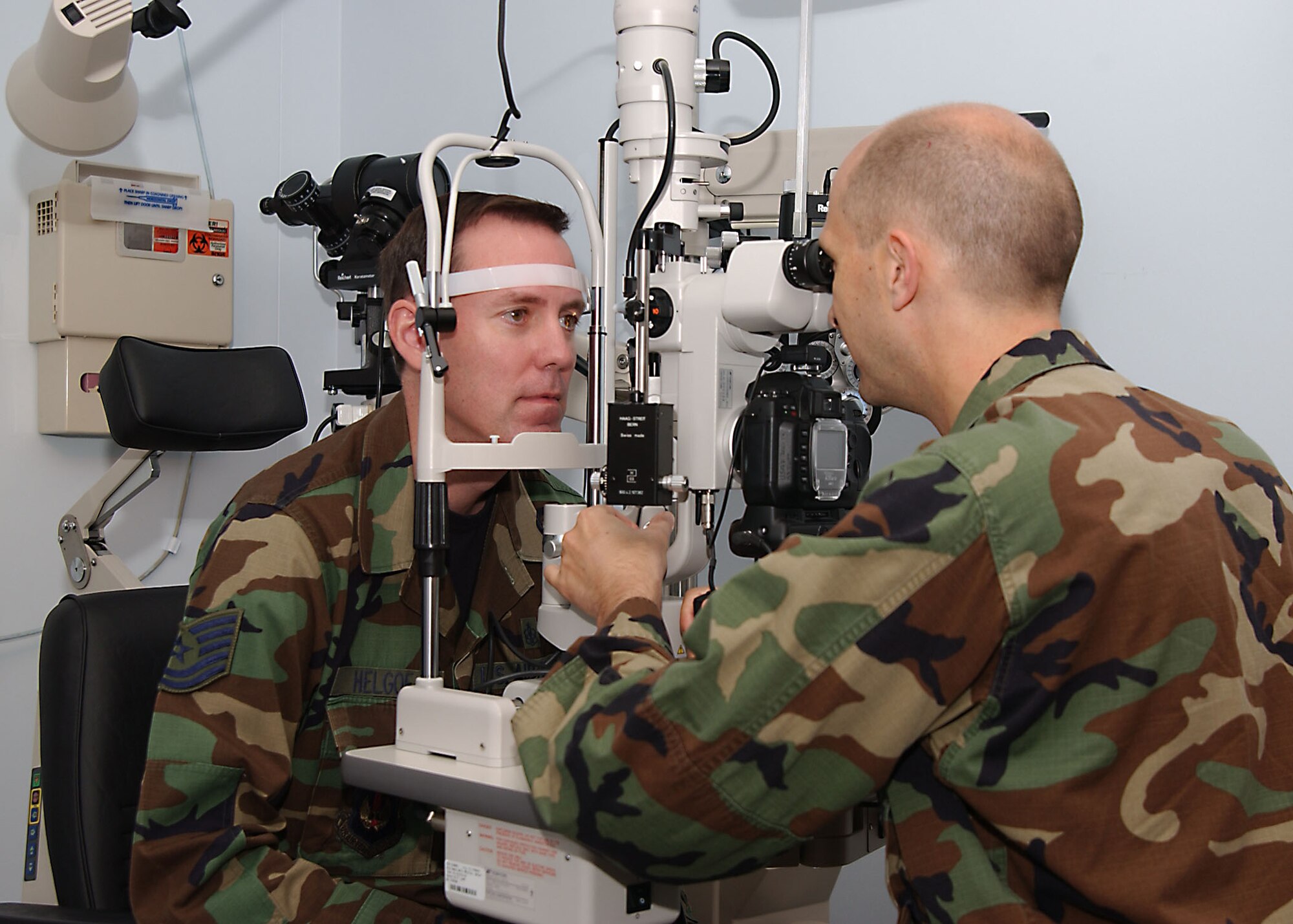 Maj DeMordant, 39th Medical Group optometrist, evaluates Tech. Sgt. Helgoes eyesight by the way of an optometry microscope.  (U. S. Air Force photo by Tech. Sgt. Patrick R. Hyde)                             