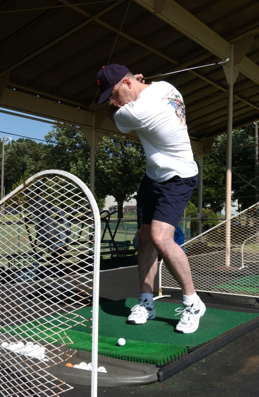 SSgt Eric Cullen, from the 374th Communicatons squadron, sets up a drive at the Yokota Par 3 on June 15, 2007.  SSgt Cullen is participating in the Domo Days program that offers free lessens to young Airmen.  (U.S. Air Force Photo by Airman First Class Jonathan Fowler)
                               