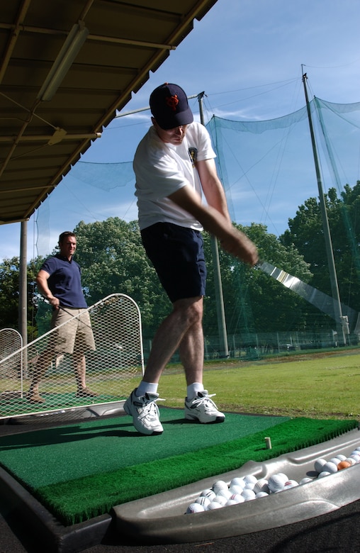 SSgt Eric Cullen, from the 374th Communicatons squadron, practices his golf swing at the Yokota Par 3 on June 15, 2007.  SSgt Cullen is participating in the Domo Days program that offers free lessens to young Airmen.  (U.S. Air Force Photo by Airman First Class Jonathan Fowler)
                              
