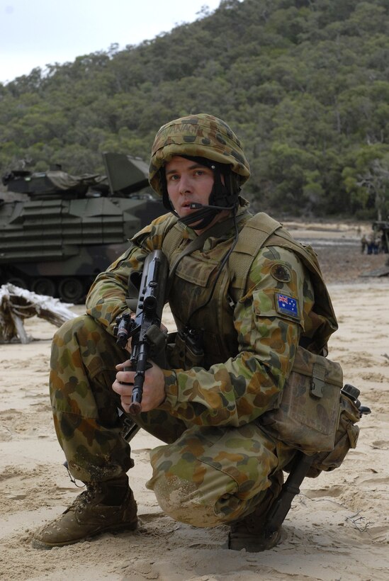 An Australian soldier takes a defensive position on the beach June 17 ...