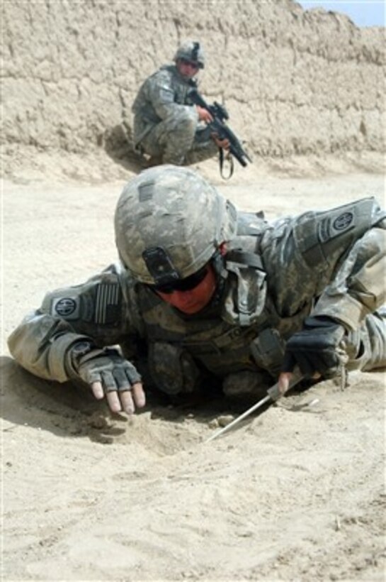 Sgt. Dennis Toney, U.S. Army, probes for a mine at a suspected site near Tangay, Afghanistan, on June 7, 2007.  Toney is with Alpha Company, 4th Brigade Special Troops Battalion.  