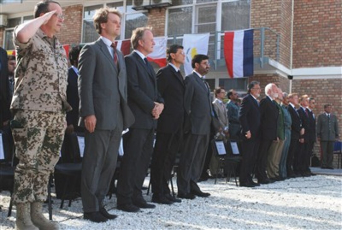 Afghan and European dignitaries render honors during a ceremony marking the symbolic turnover of the mission to train the Afghan National Police, from the German Police Project Office to the European Union Police mission in Kabul, Afghanistan, June 17, 2007.