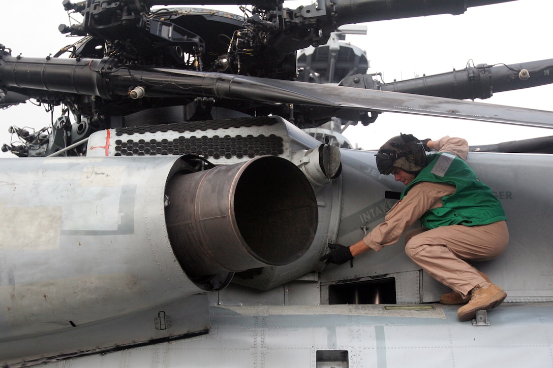 Captain Pete Lisowski, a CH-53E Super Stallion transport helicopter pilot with Marine Medium Helicopter Squadron 261, performs preflight operations checks on a Super Stallion during the 22nd Marine Expeditionary Unit's Certification Exercise aboard the USS Kearsarge, June 20, 2007. The Marines and sailors of HMM-261 are scheduled to deploy as the Aviation Combat Element of the 22nd MEU later this summer. (Official Marine Corps photo by Cpl. Peter R. Miller)::n::