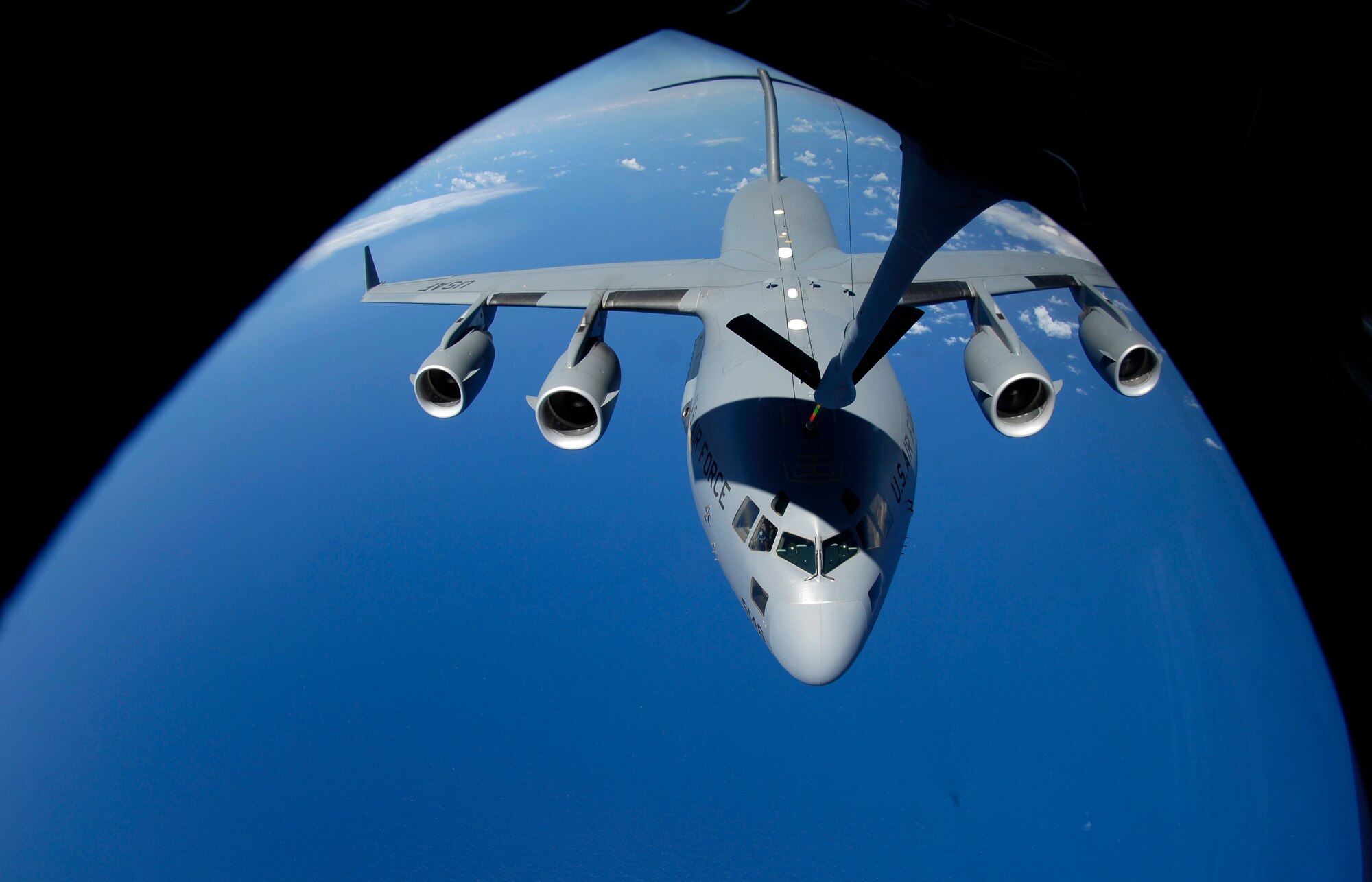 A C-17 Globemaster III receives fuel from a KC-135 Stratotanker during aerial refueling practice over the skies of Hawaii. A KC-135 Stratotanker from the 909th Air Refueling Squadron, 18th Wing, Kadena Air Base, Japan is at Hickam Air Force Base, Hawaii practicing with a C-17 Globemaster III from the 535th Airlift Squadron for the Air Mobility Command Rodeo. (U.S. Air Force photo/ Tech. Sgt. Shane A. Cuomo)