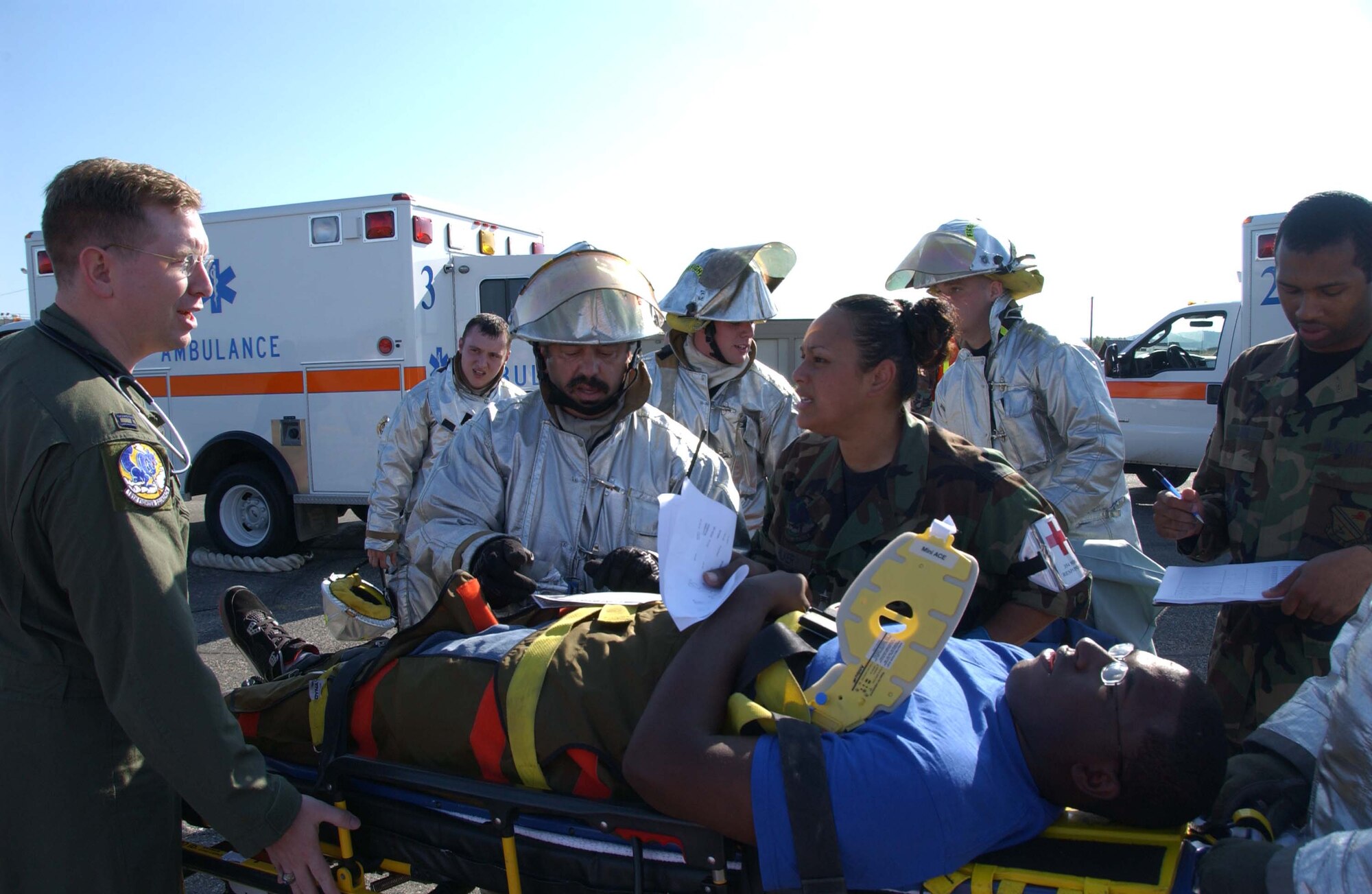 EIELSON AIR FORCE BASE, Alaska --  354th Civil Engineer Squadron and 354th Medical Group members discuss what next to do with an injured bystander June 19 here. Eielson held an emergency management exercise to help in the readiness and response in case of unforeseen events, both of the squadrons work together to maintain safety on the crash site and the health of those who were injured from a simulated F-16 crash.(U.S. Air Force photo by Airman 1st Class Christopher Griffin)