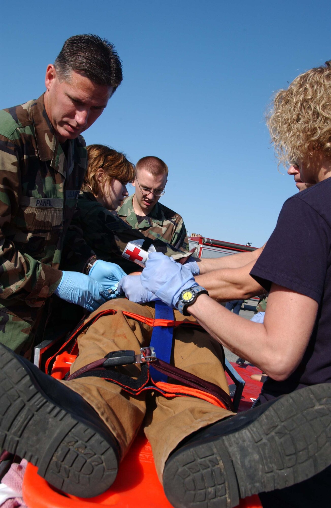 EIELSON AIR FORCE BASE, Alaska --  354th Medical Group members help in the aid of an injured bystander June 19 here. Eielson held an emergency management exercise to help in the readiness and response in case of unforeseen events, members of the medical group attend to those who are injured and to make sure they get the attention and care they need.   (U.S. Air Force photo by Airman 1st Class Christopher Griffin)