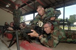 Staff Sgt. Steven King, 437th Security Forces Squadron NCO in charge of combat arms, assists Col. Frank Jones, 437th Mission Support Group commander, with preparing his M4 prior to qualifying at the combat arms firing range.  (U.S. Air Force photo/ Staff Sgt. April Quintanilla)