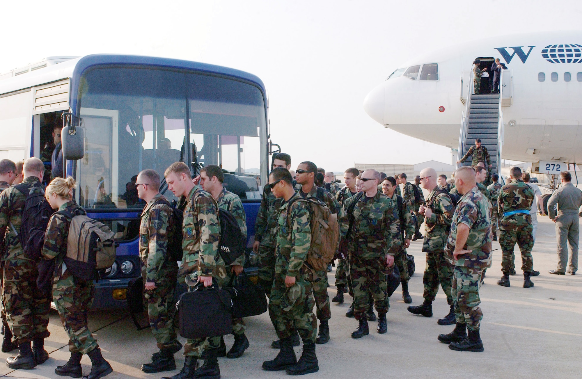 Airman from the 555th Fighter Squadron, Aviano Air Base, Italy, load onto a bus here at Kunsan Air Base, Republic of Korea for their 120 day deployment.  This is the first time that a US Air Forces in Europe base has deployed to a Pacific Air Force base.  (US Air Force photo by Senior Airman Steven R. Doty)                               
