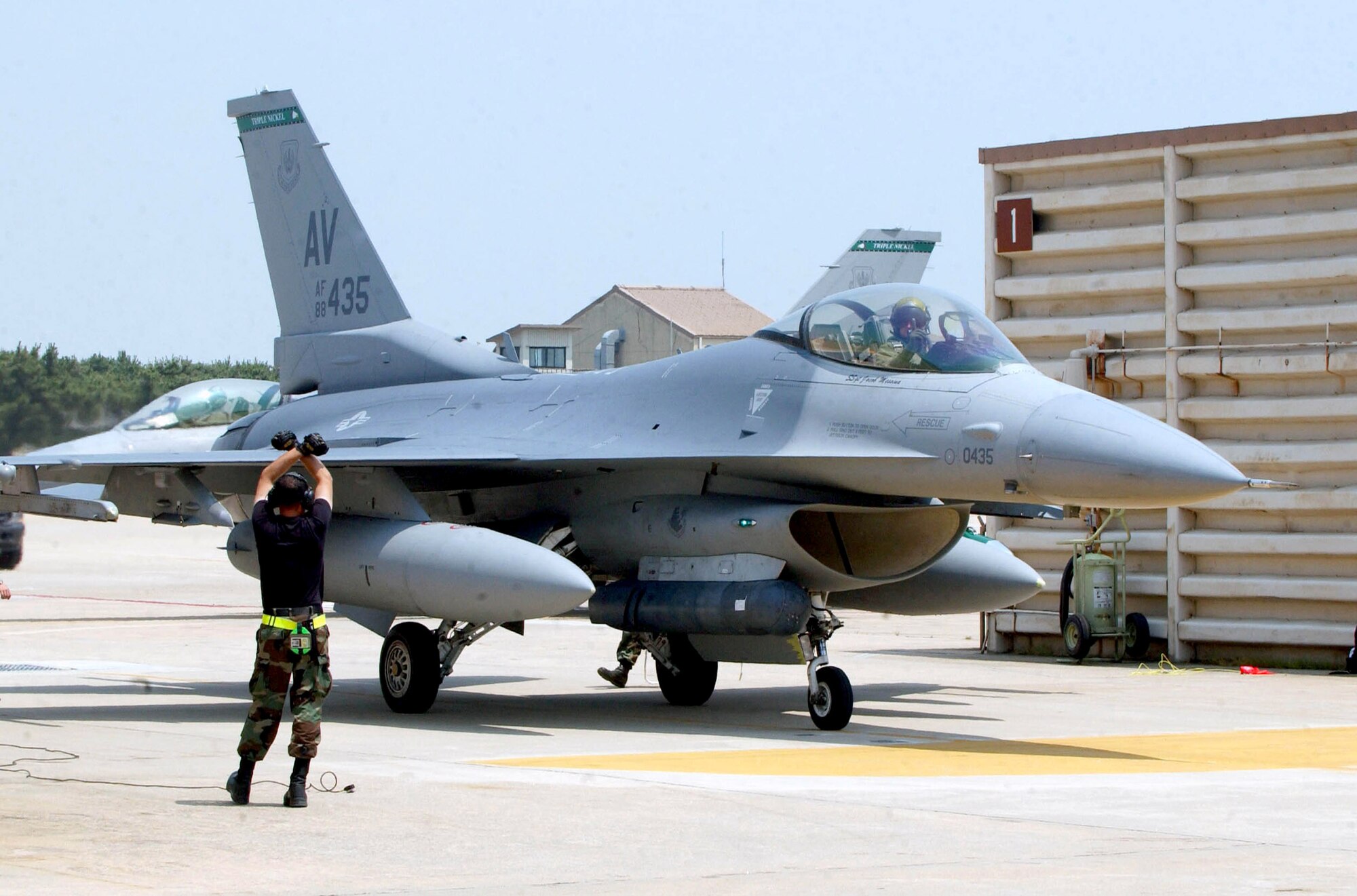 Lt. Col. Clay Hall pulls to a stop with the direction of his maintainers June 19 at Kunsan Air Base, South Korea.  Colonel Hall and other pilots arrived to Kunsan AB from Aviano Air Base, Italy.  This is the first time a U.S. Air Forces in Europe fighter unit has deployed to a Pacific Air Force base. (U.S. Air Force photo/Senior Airman Steven R. Doty)
