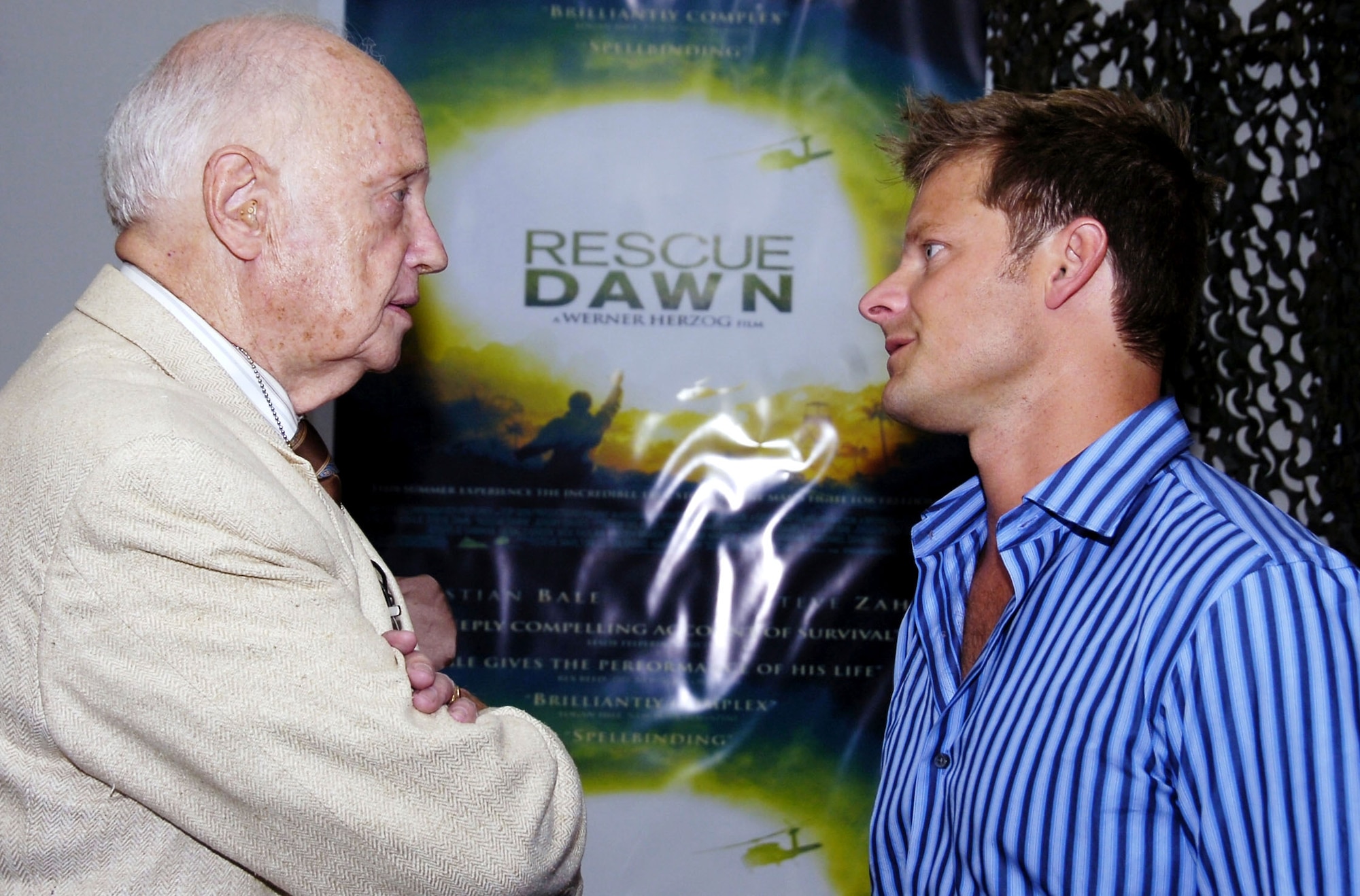 Retired Air Force Col. Eugene Deatrick, left, who rescued Navy Lt. Dieter Dengler, a POW during the Vietnam War, chats with Steve Zahn, who plays Air Force 1st Lt. Duane Martin in the movie "Rescue Dawn. The movie is about Lieutenant Dengler's capture and escape. Colonel Deatrick and Mr. Zahn met during a June 18 premiere at Andrews Air Force Base, Md. "Rescue Dawn will be out in theaters in New York and Los Angeles July 4, then go nationwide July 13. (U.S. Air Force photo/Bobby Jones)