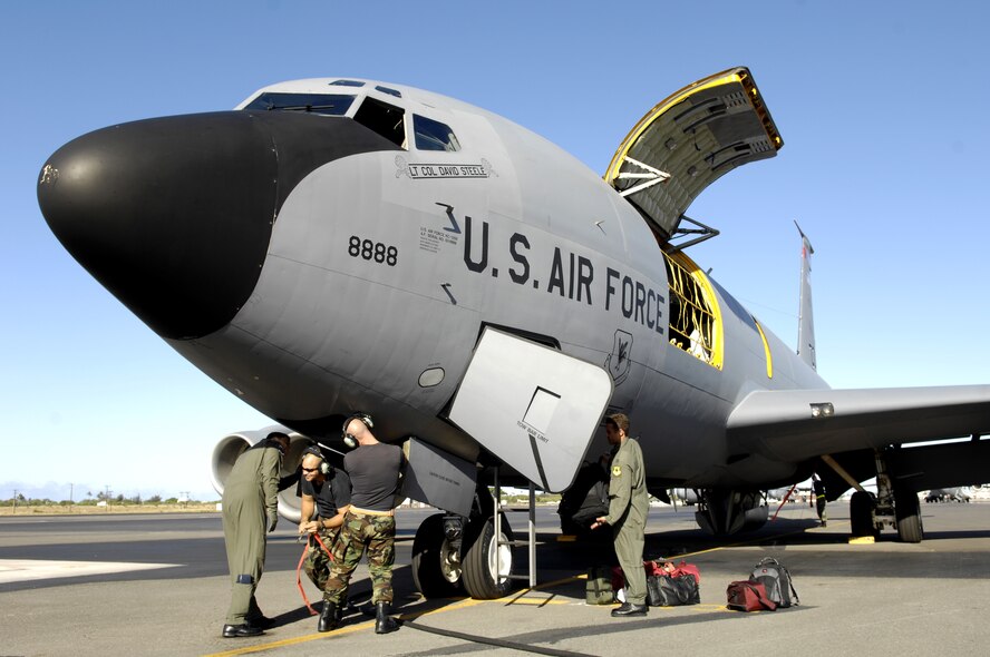 Aircrew and maintenance personnel prepare to launch for a refueling mission from Hickam Air Force Base, Hawaii June 18, 2007. A KC-135 Stratotanker from the 18th Wing, Kadena Air Base, Japan is at Hickam practicing with a C-17 Globemaster III from the 535th Airlift Squadron for the Air Mobility Command Rodeo. The Airmen are with the 909th Air Refueling Squadron. (U.S. Air Force photo/ Tech. Sgt. Shane A. Cuomo)