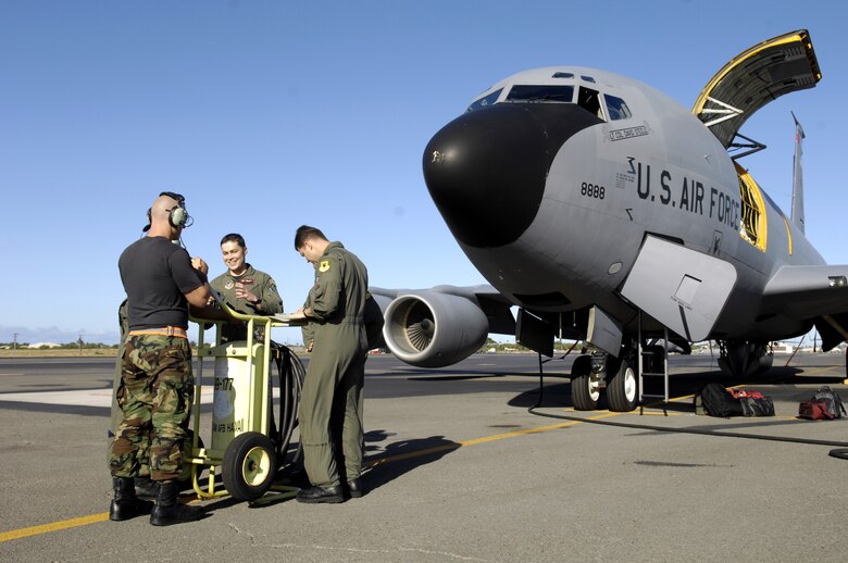 Aircrew and maintenance personnel prepare to launch for a refueling mission from Hickam Air Force Base, Hawaii June 18, 2007. A KC-135 Stratotanker from the 18th Wing, Kadena Air Base, Japan is at Hickam practicing with a C-17 Globemaster III from the 535th Airlift Squadron for the Air Mobility Command Rodeo. The Airmen are with the 909th Air Refueling Squadron. (U.S. Air Force photo/ Tech. Sgt. Shane A. Cuomo)