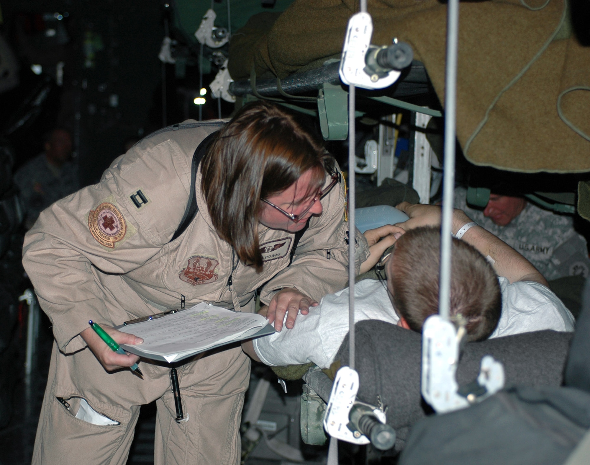 Capt. Rhea Downs cares for a wounded servicemember June 13 at Balad Air Base, Iraq. Captain Downs is deployed from Pope AFB, N.C., and is assigned to the 379th Expeditionary Aeromedical Evacuation Squadron. (U.S. Air Force photo/Staff Sgt. Cassandra Locke)