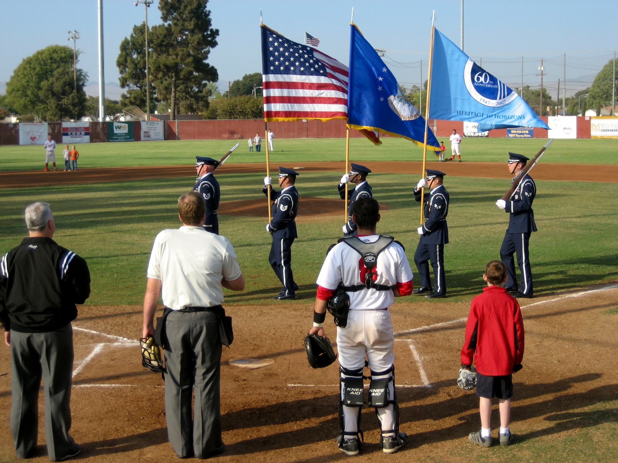 Vandenberg Honor Guardsmen post the colors while the National Anthem plays during the military appreciation night at Santa Maria's Elks Field.  The game was free to active duty and retired military and their families and featured the Santa Maria Indians who beat the Paso Robles Reds 3-2. (U.S. Air Force photo/Staff Sgt. Samuel Bendet)