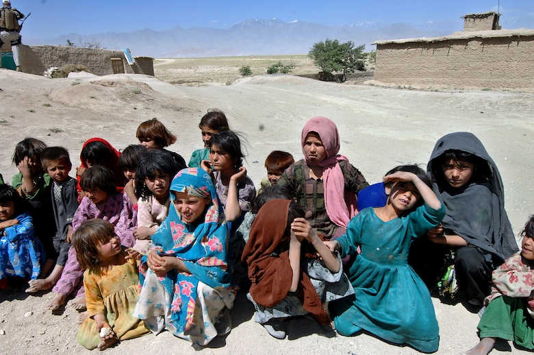 A group of young girls await a delivery of humanitarian supplies June 17 coming to the village of Qal' ehey Yuzbashi in Afghanistan. Lt. Gen. John Bradley, the Air Force Reserve Command commander and chief, was delivering the supplies to the village located near Bagram Air Base. The supplies, destined for refugee camps, orphanages and hospitals throughout Southwest Asia, are part of the 9,000 pounds collected by General Bradley's wife, Mrs. Jan Bradley. General Bradley is visiting Airmen throughout Southwest Asia to thank them for their service supporting the war on terrorism. (U.S. Air Force photo/Tech Sgt. Rick Sforza)